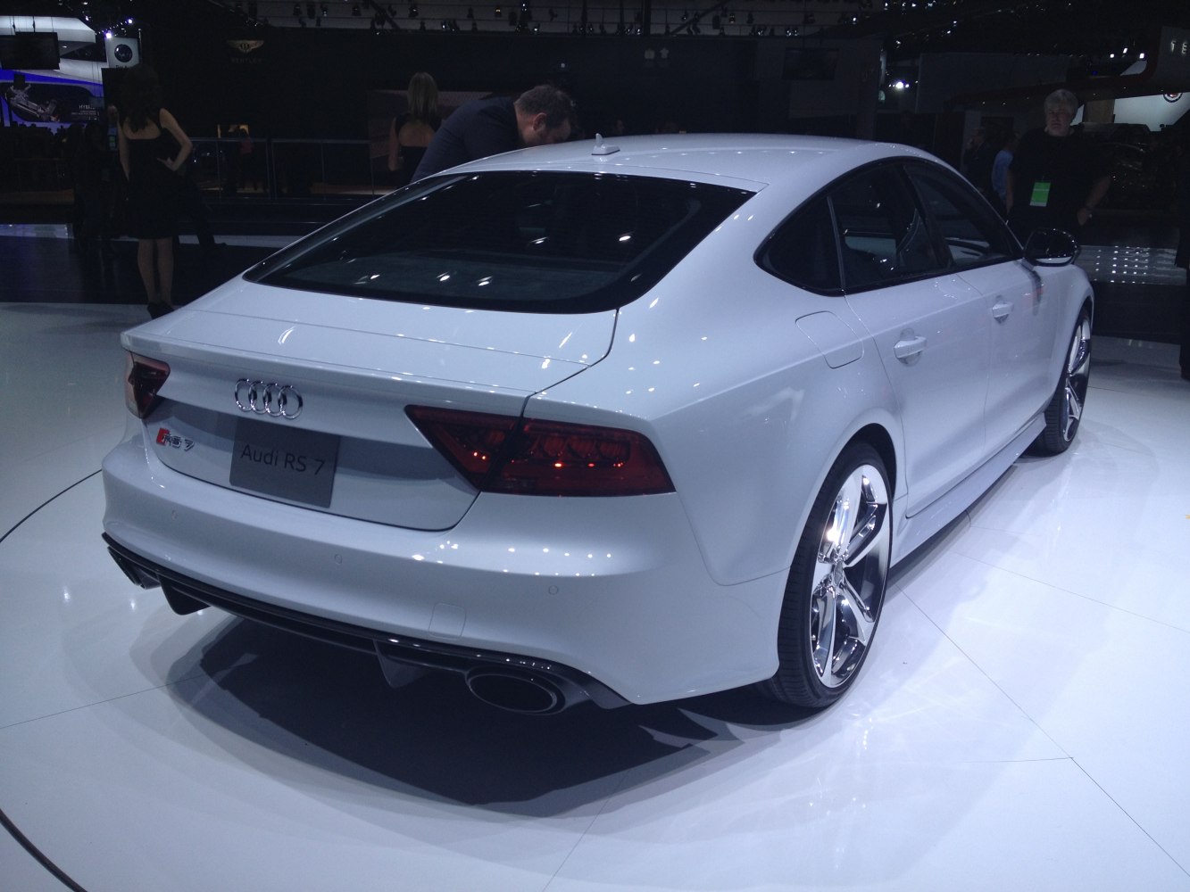 Rear and side view with sleek lines, alloy wheels, quad exhaust