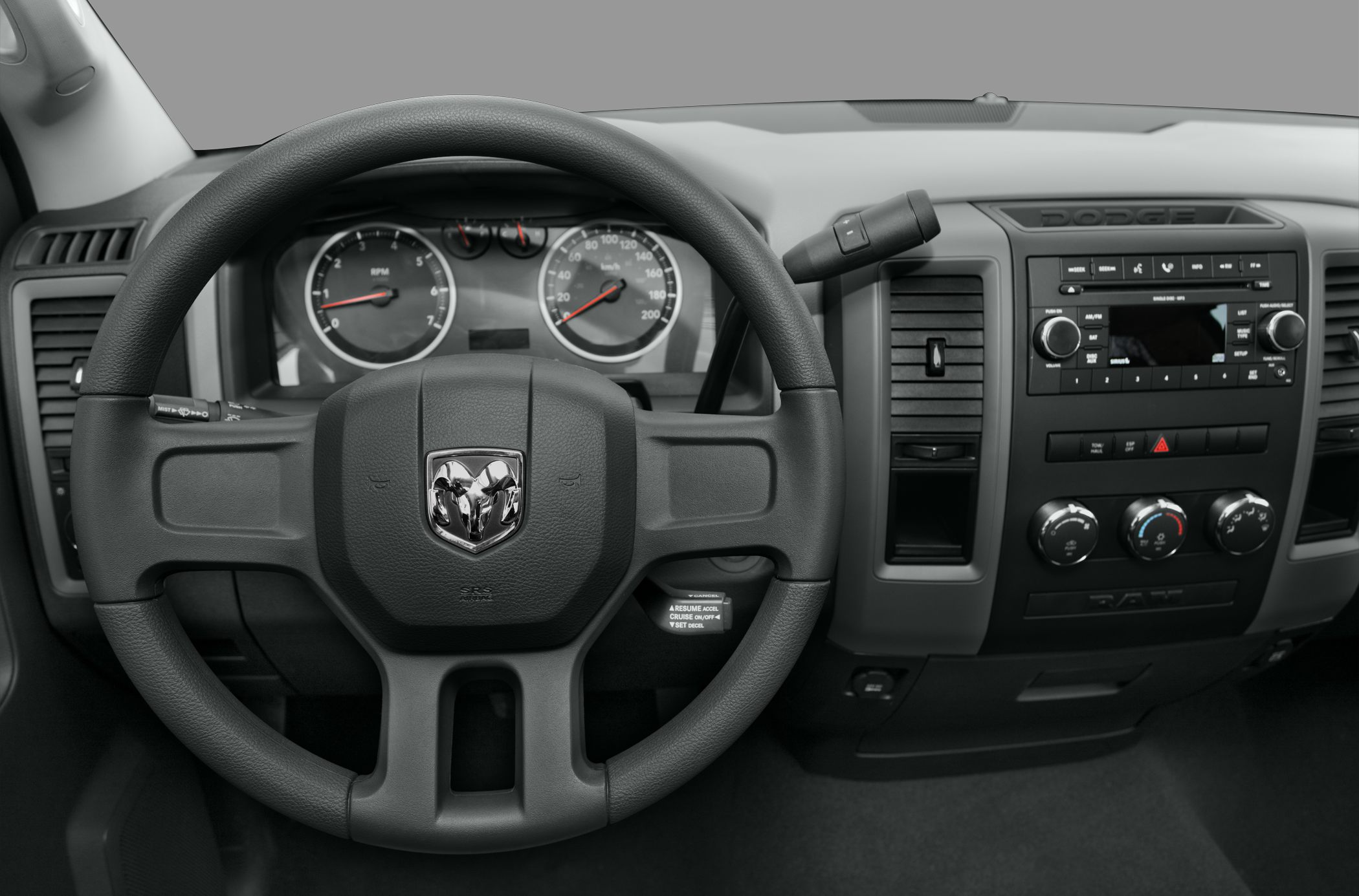 Dashboard and steering wheel with instrument cluster and control knobs.