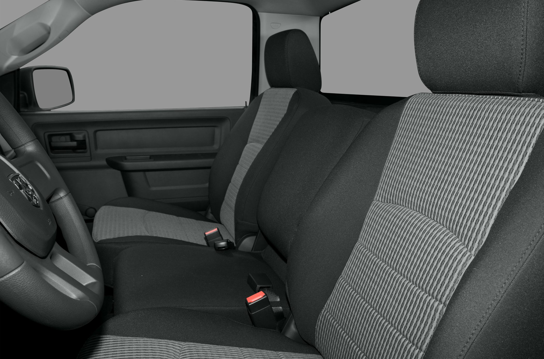 Front and middle seats with black and gray fabric upholstery and visible seatbelt buckles