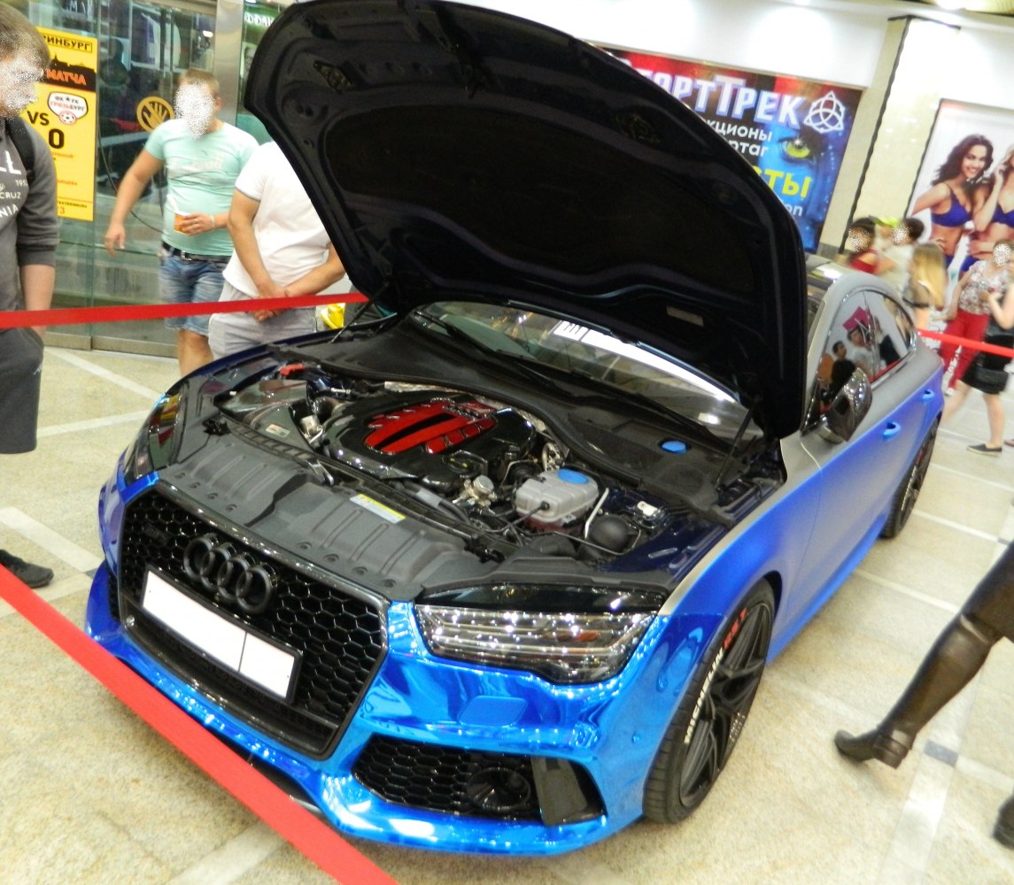 Open engine bay with glossy front grille and headlights
