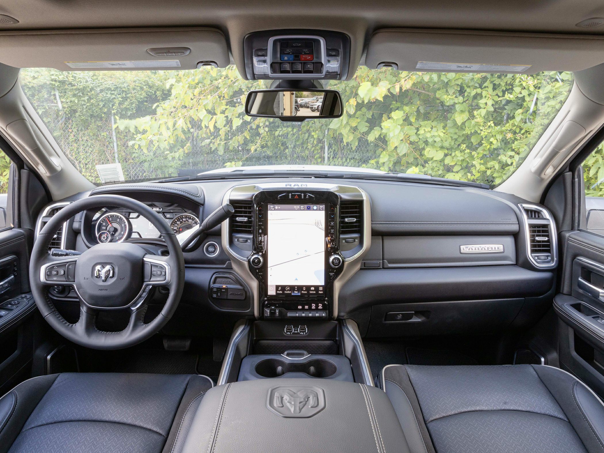 Interior with large touchscreen, multifunction steering wheel, and premium dashboard.
