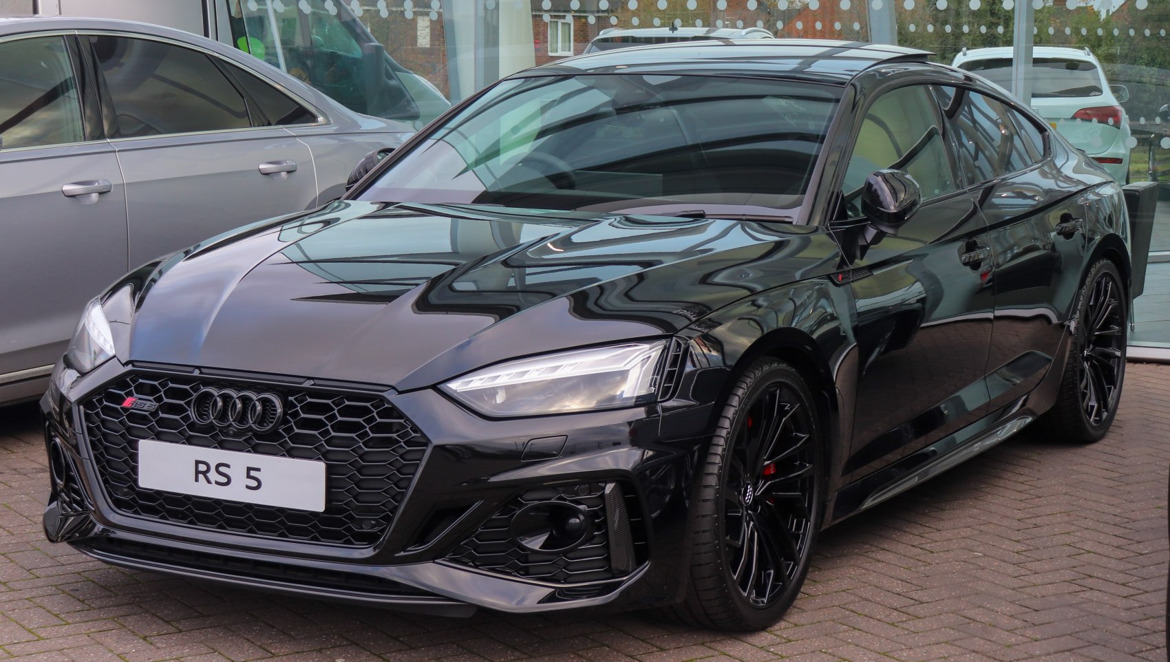 Aggressive RS5 Sportback front grille and LED headlights in black.