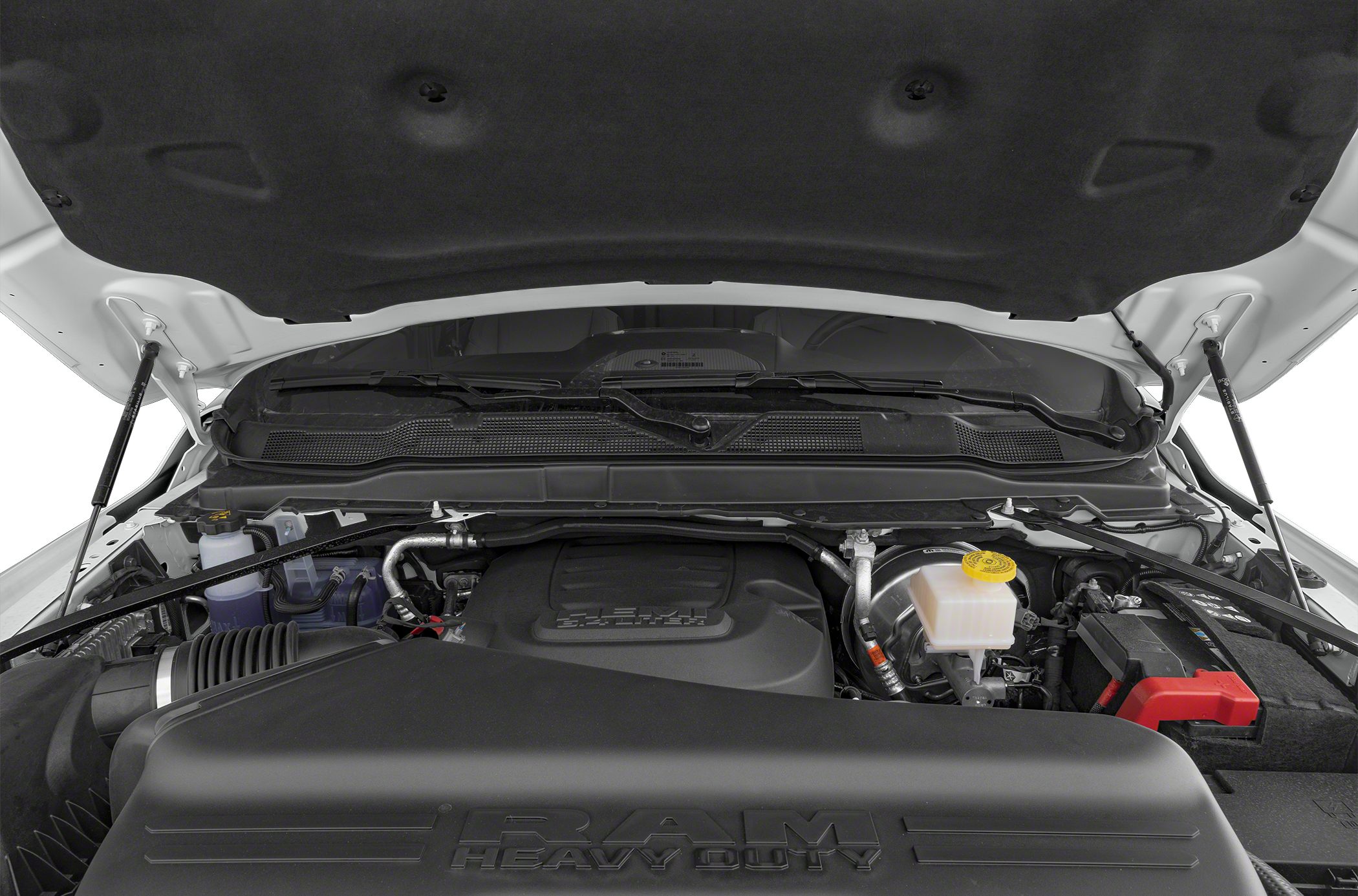 Heavy duty truck engine bay with RAM Heavy Duty embossed cover and key components.