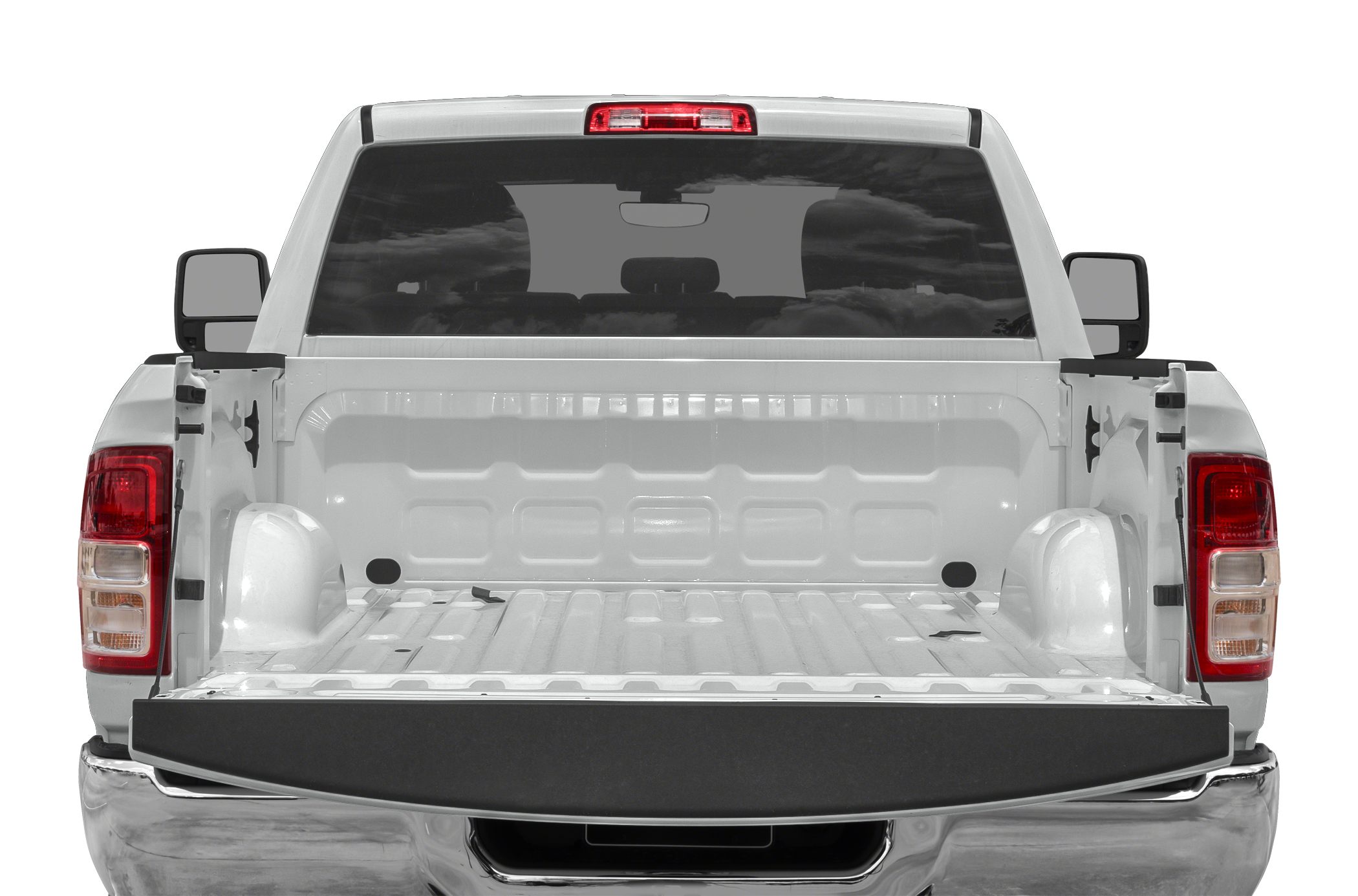 Open cargo bed with lowered tailgate on heavy-duty pickup.