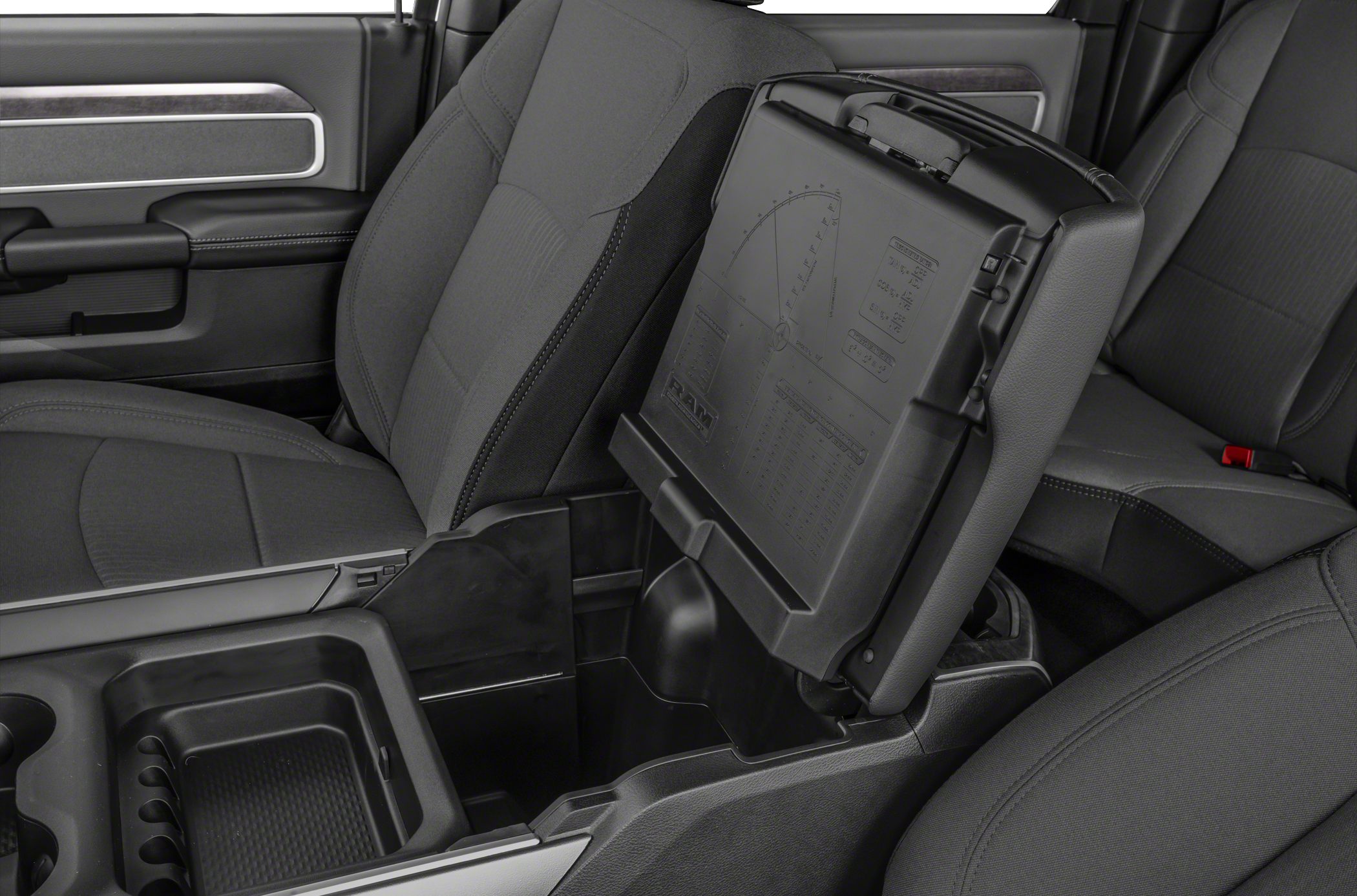 Open center console storage with cup holders and seat upholstery.