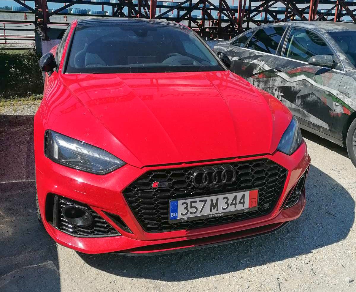 Aggressive front grille and sharp LED headlights of a red coupe
