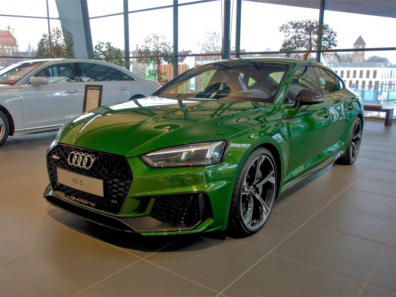 Green sporty car with aggressive front grille and sleek design