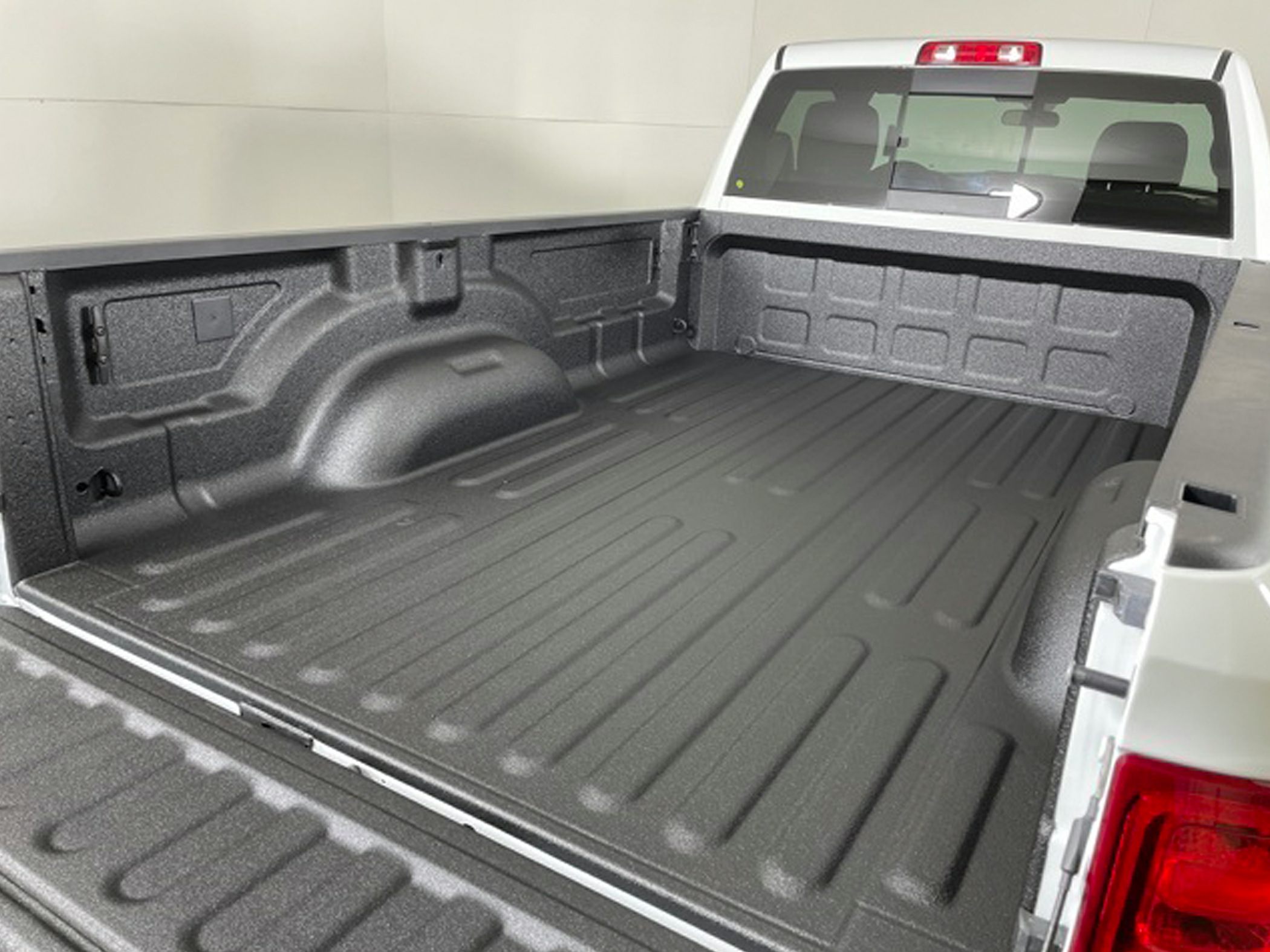 Textured heavy-duty truck bed liner in a pickup truck bed