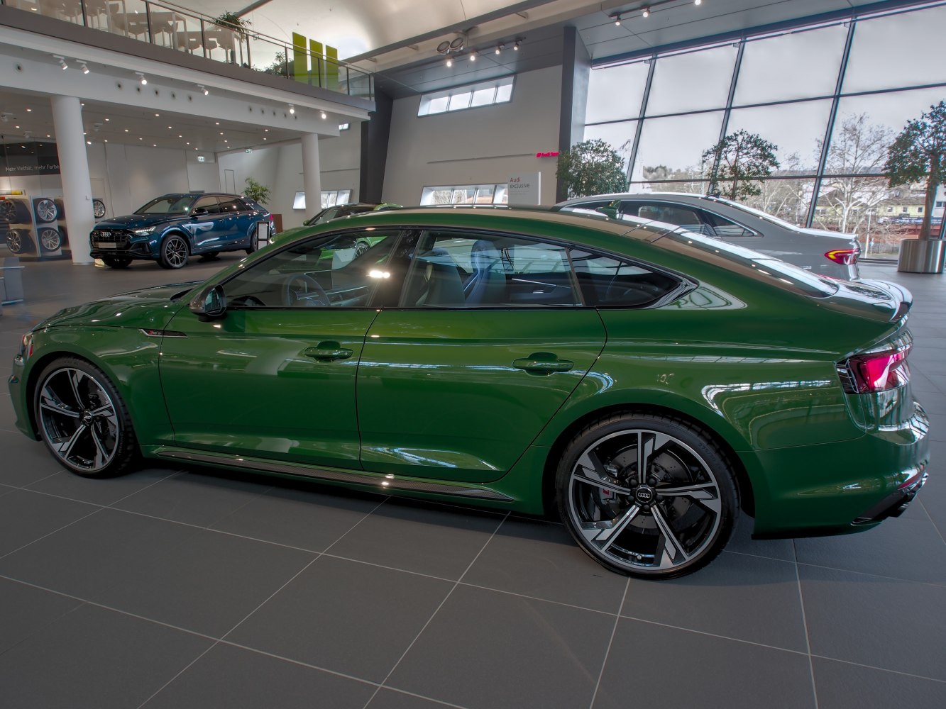 Green 4-door sportback with large alloy wheels and tinted windows