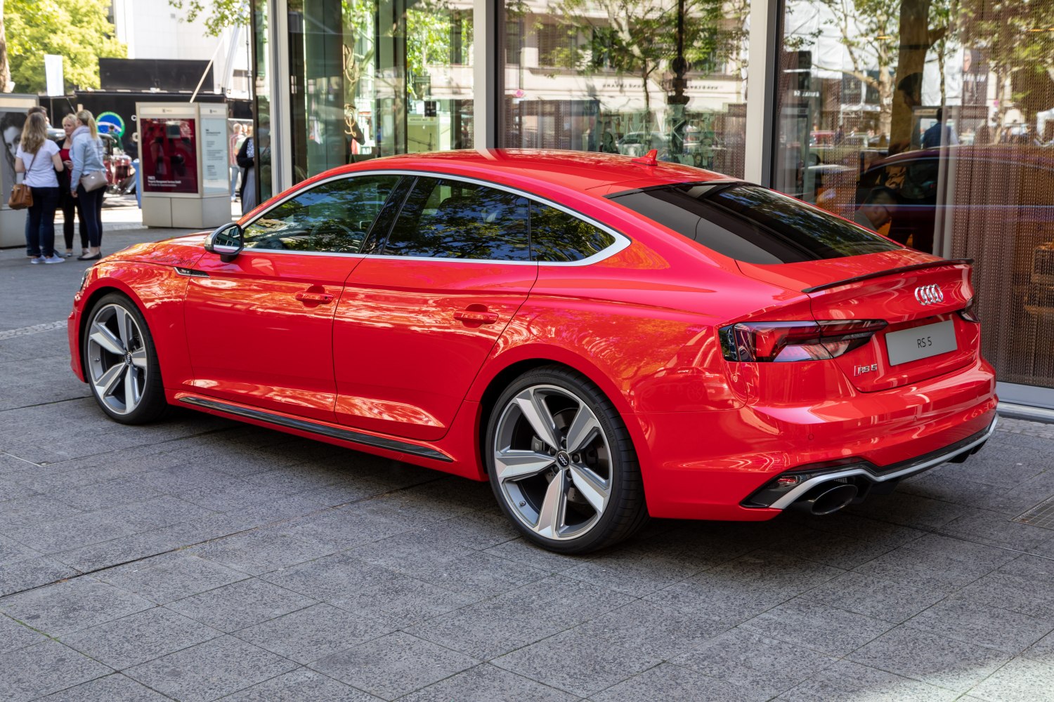 Red luxury five-door coupe with distinctive alloy wheels