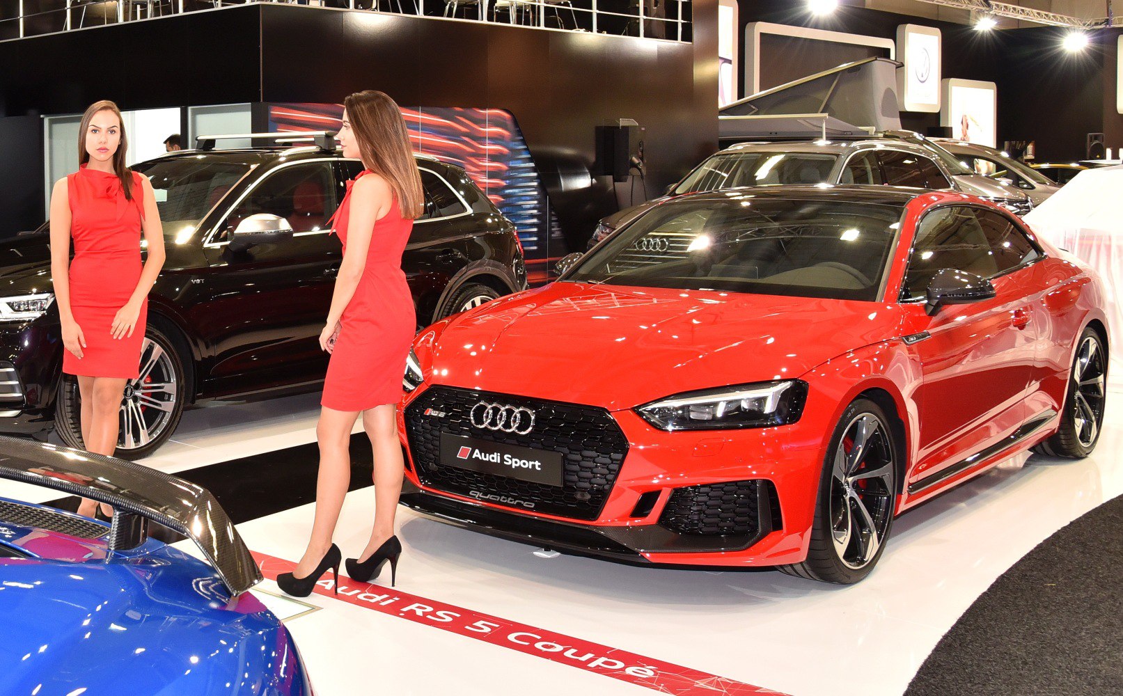 Red sporty coupe with dynamic grille and sleek alloy wheels