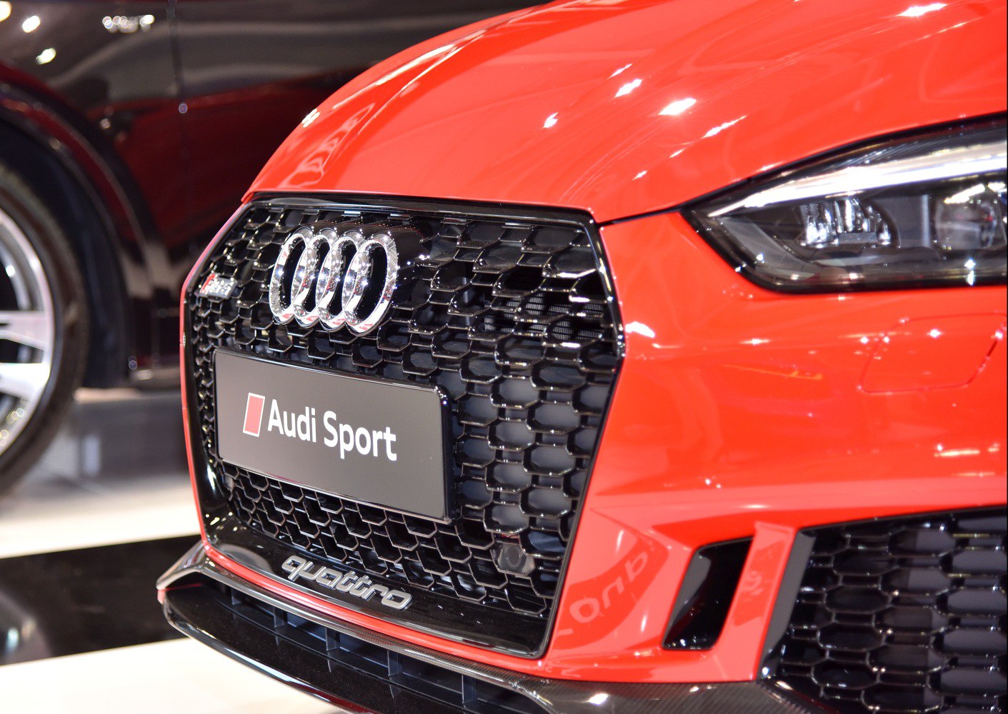 Close-up of front honeycomb grille and LED headlight
