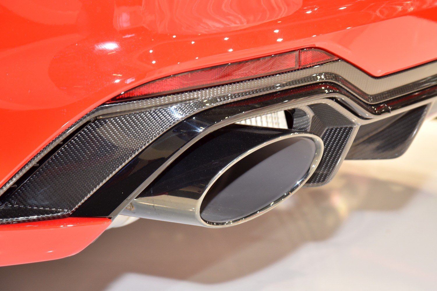 Carbon fiber rear diffuser and oval exhaust tip on a sports coupe