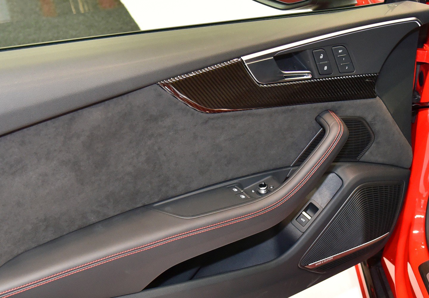 Door panel with red stitching and carbon fiber trim