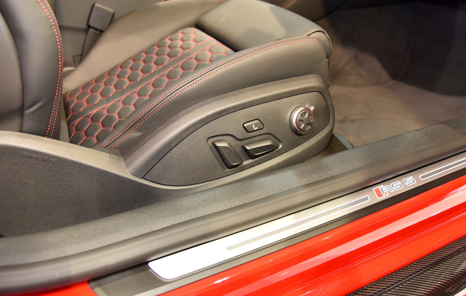 Electric adjustable sport seat with red contrast stitching