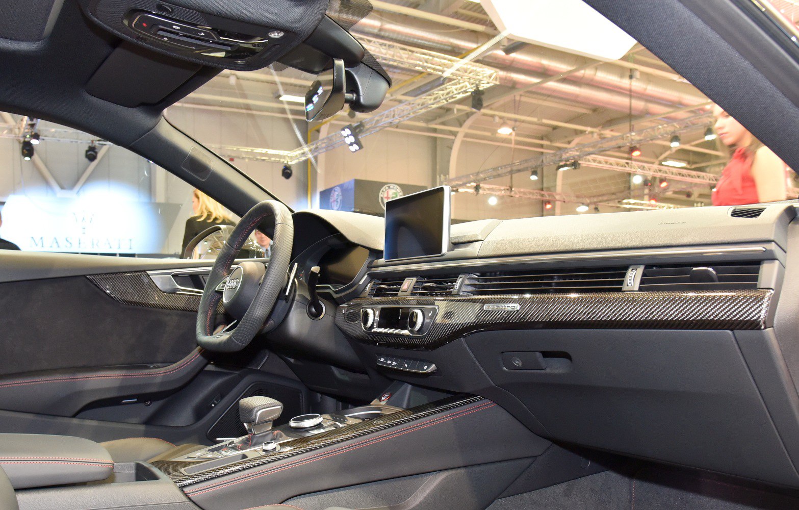 Carbon fiber trim and modern cockpit design in a sporty car interior.