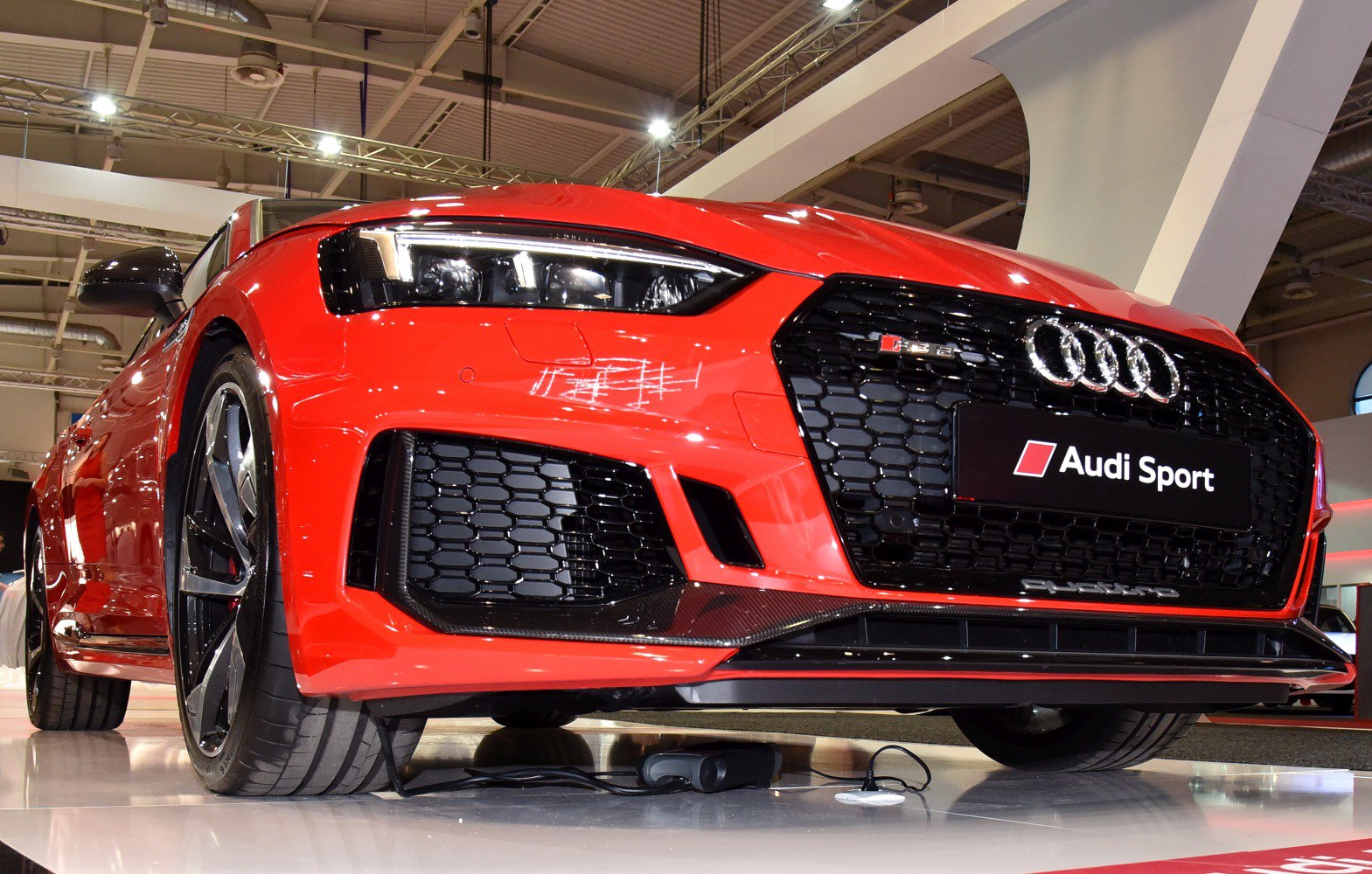 Front grille and headlight detail of red sports coupe