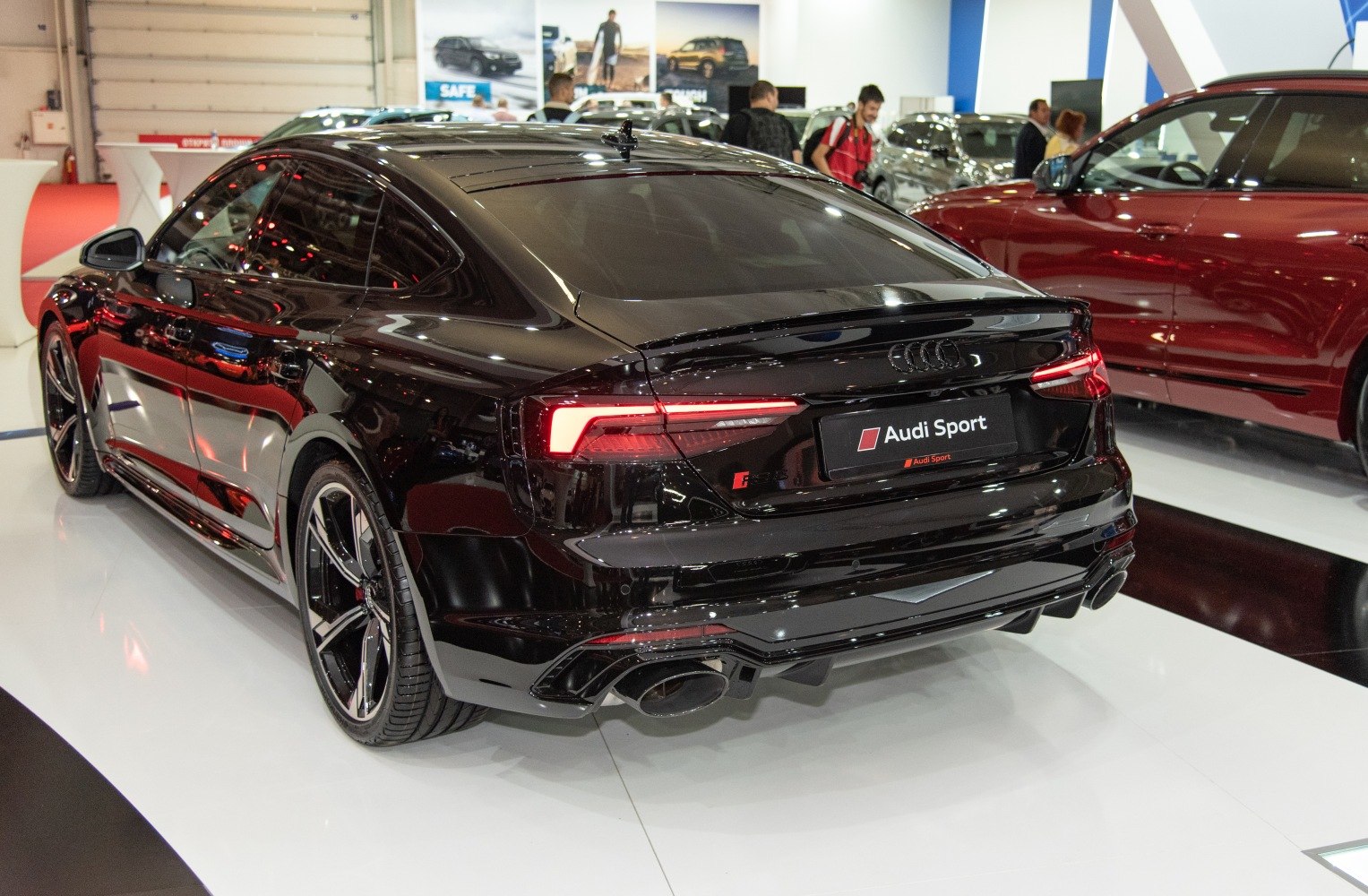 Rear view with distinctive taillights, spoiler, and sporty dual exhaust