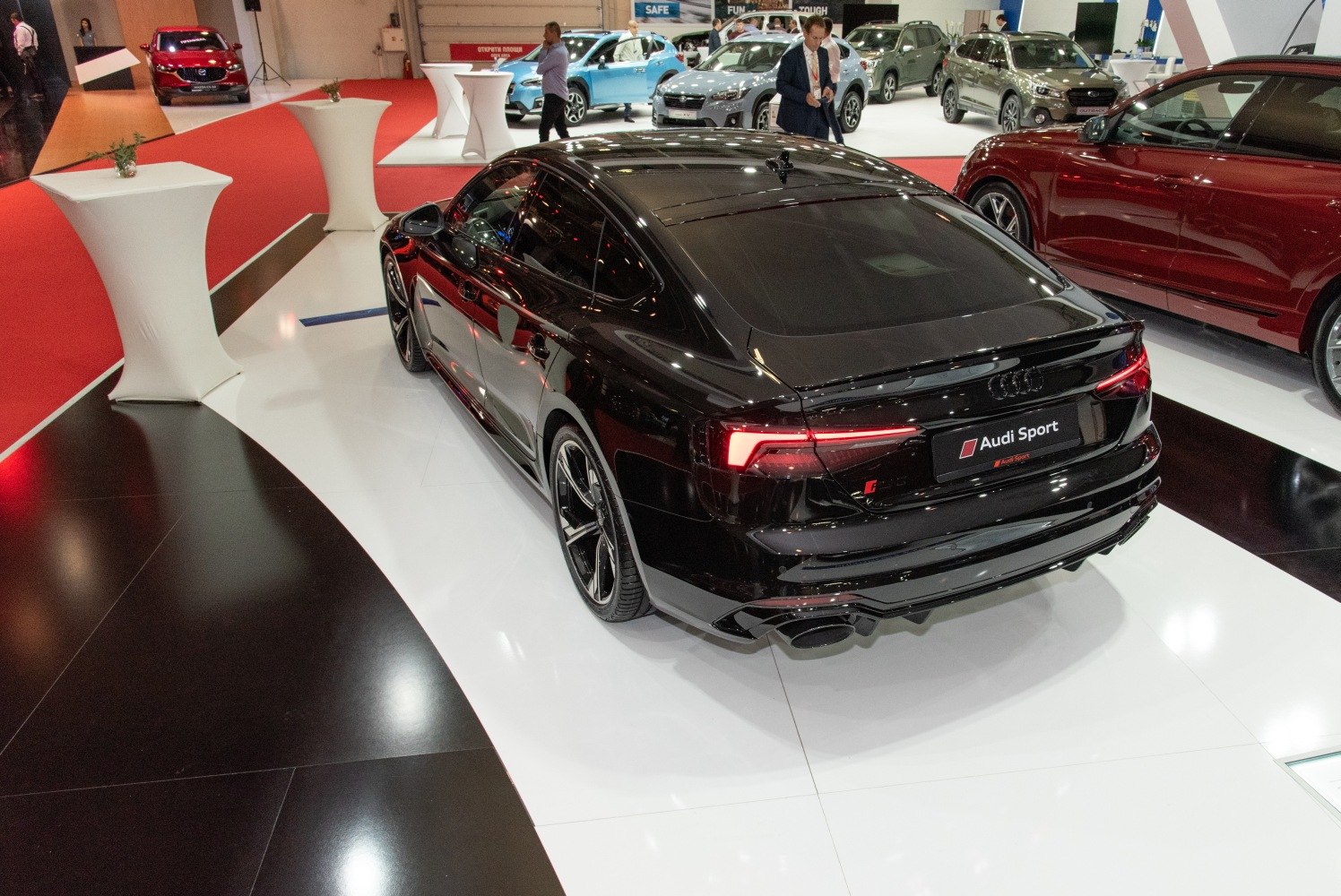 Rear view of a black sporty coupe with LED taillights and dual exhausts