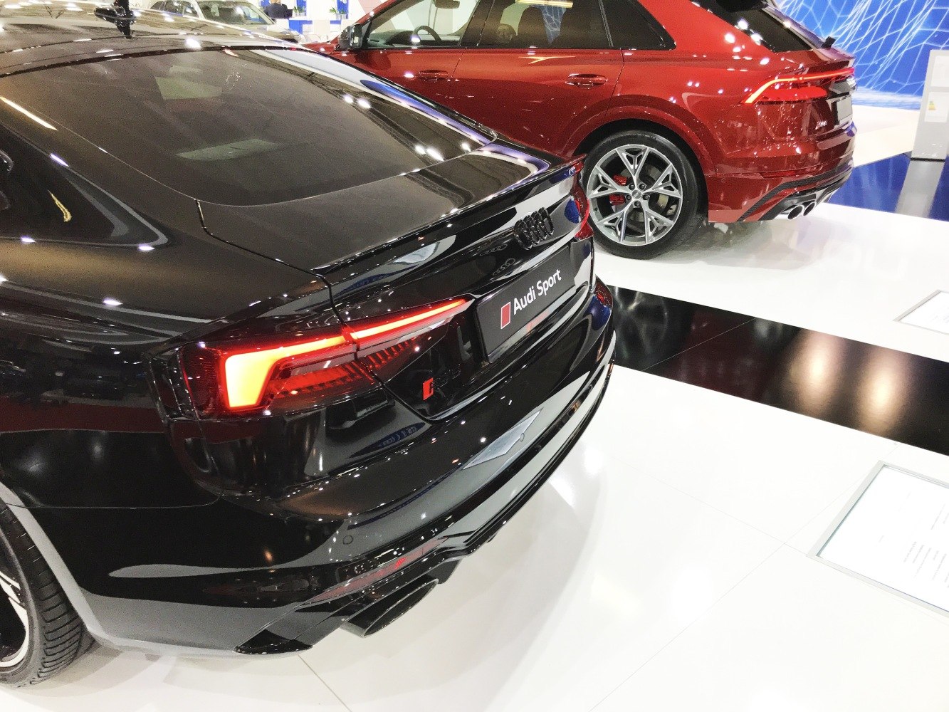 Rear design with illuminated tail lights and dual exhaust of a sport coupe