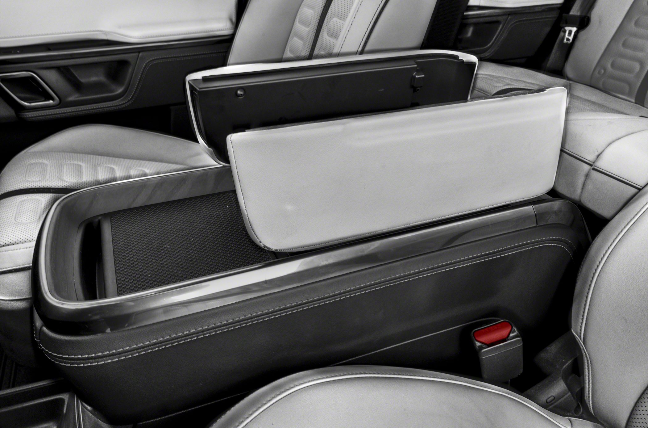 Rear seat armrest with opened storage compartment in vehicle interior