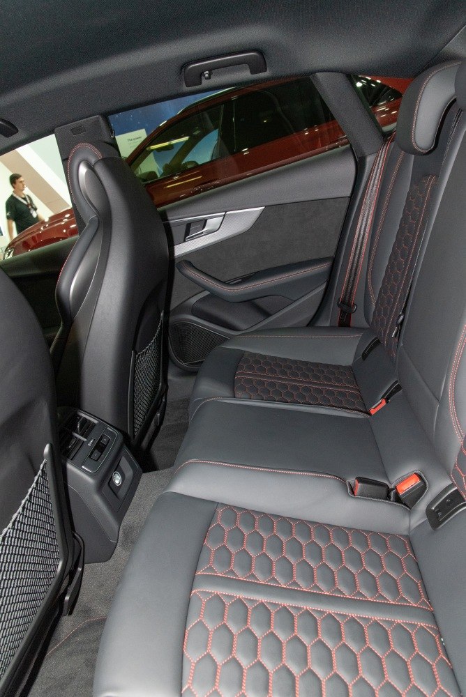 Rear seat interior with black leather and red hexagonal stitching