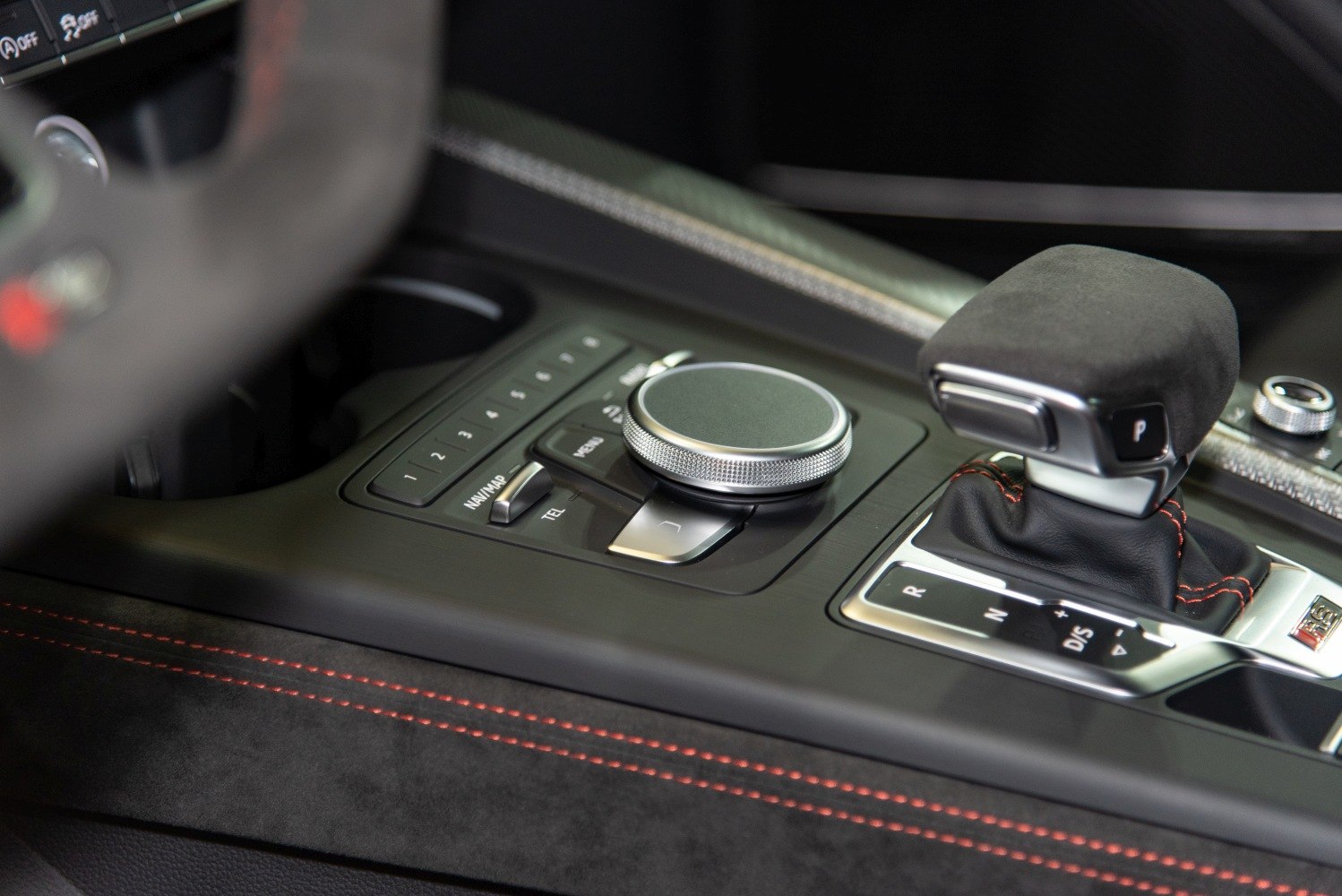 Automatic gearshift lever and multimedia control dial with red stitching