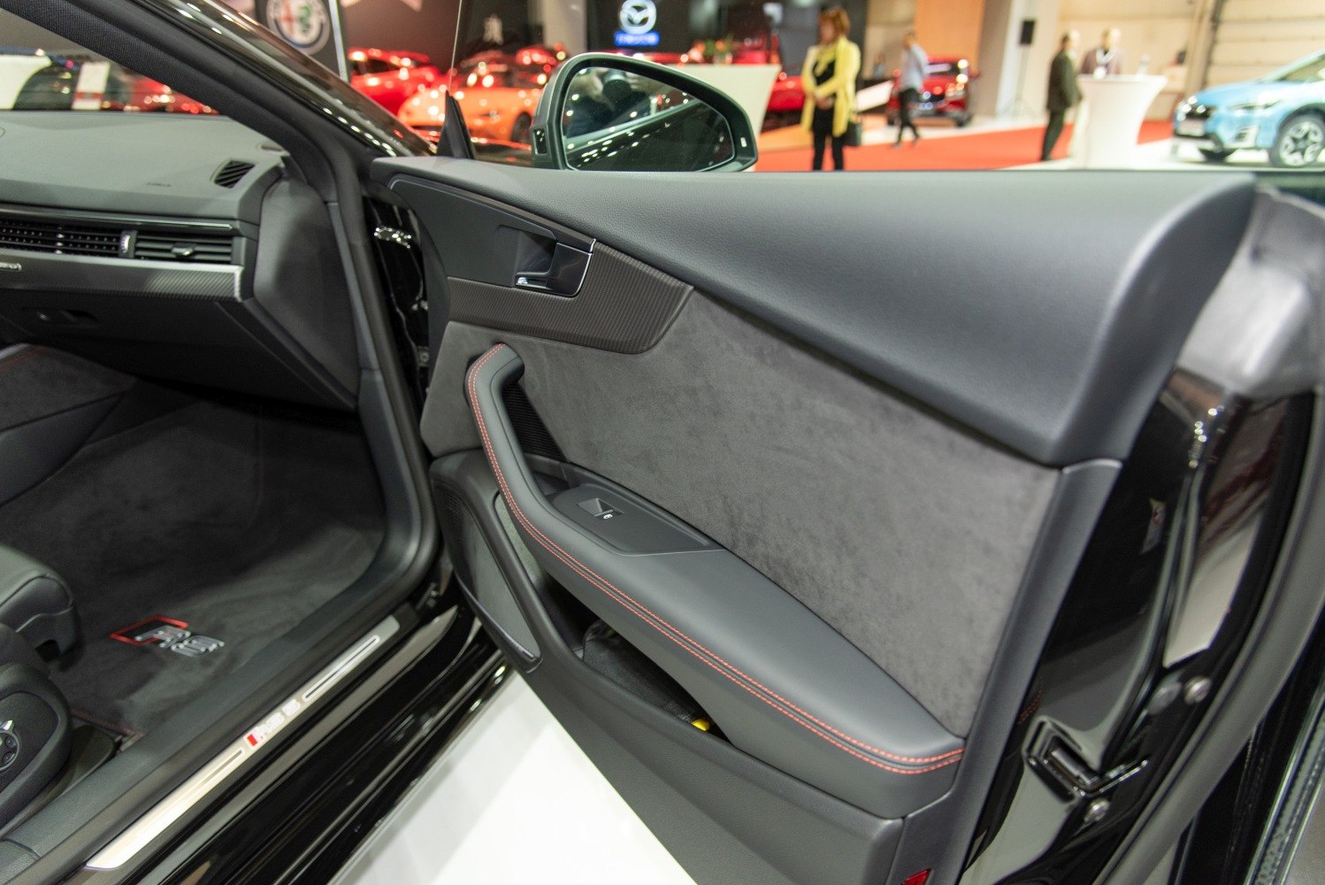Interior door panel with leather, Alcantara, and red stitching