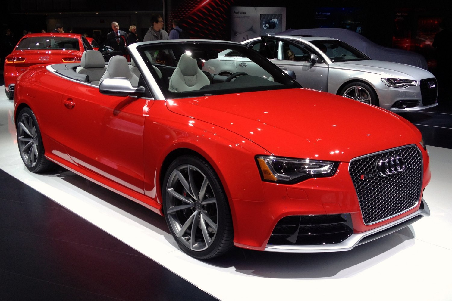 Red convertible with honeycomb grille and sporty wheels