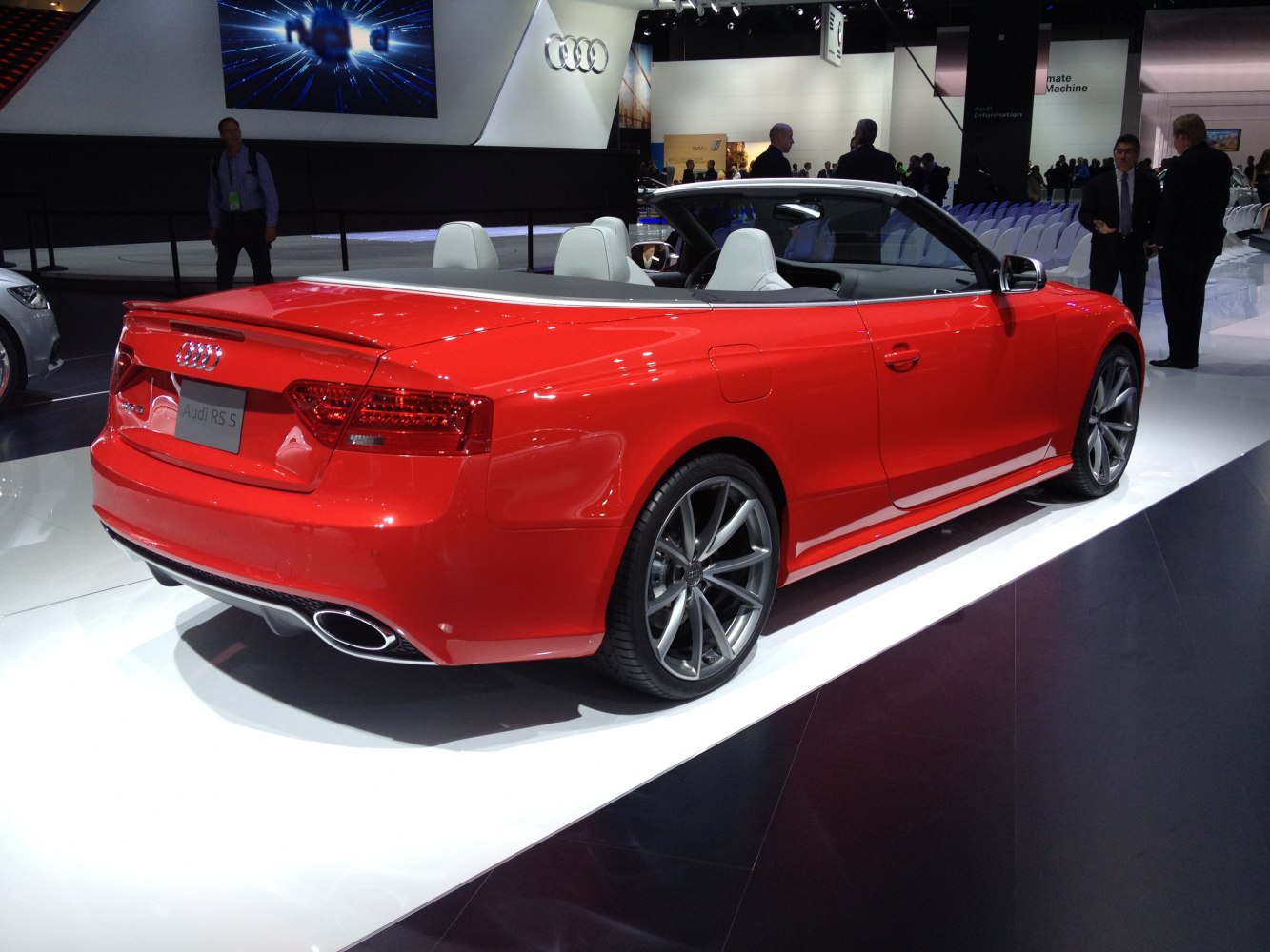Red convertible sports car rear with dual oval exhausts and alloy wheels