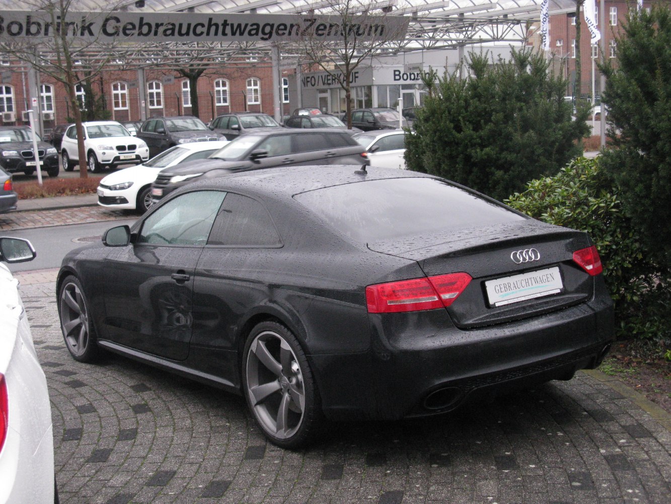 Rear three-quarter view with taillights and five-spoke alloy wheels