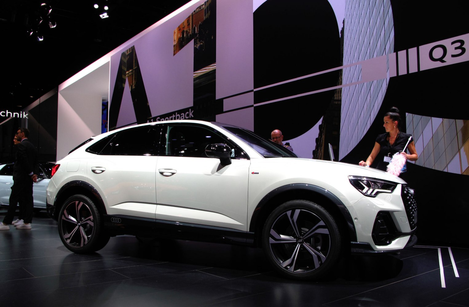 White compact luxury SUV side profile with sporty design and large alloy wheels