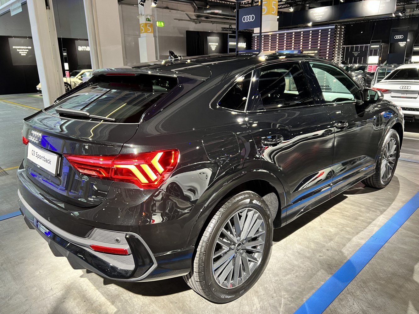 Rear side view showcasing sleek SUV design and distinctive taillights.