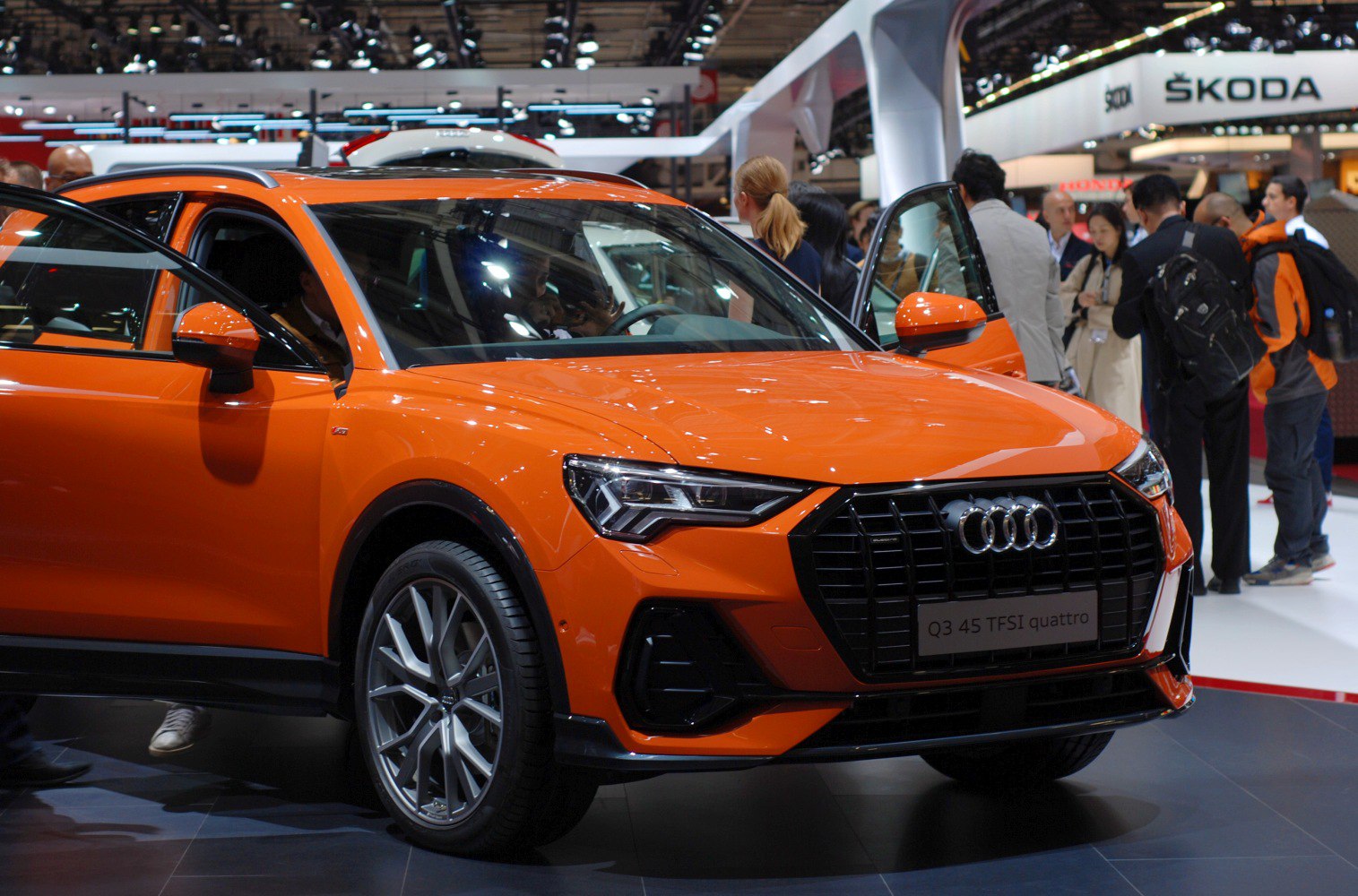 Orange SUV front with open doors and LED headlights