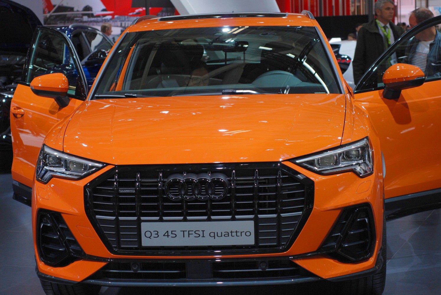 Bold front grille and LED headlights with open driver and passenger doors
