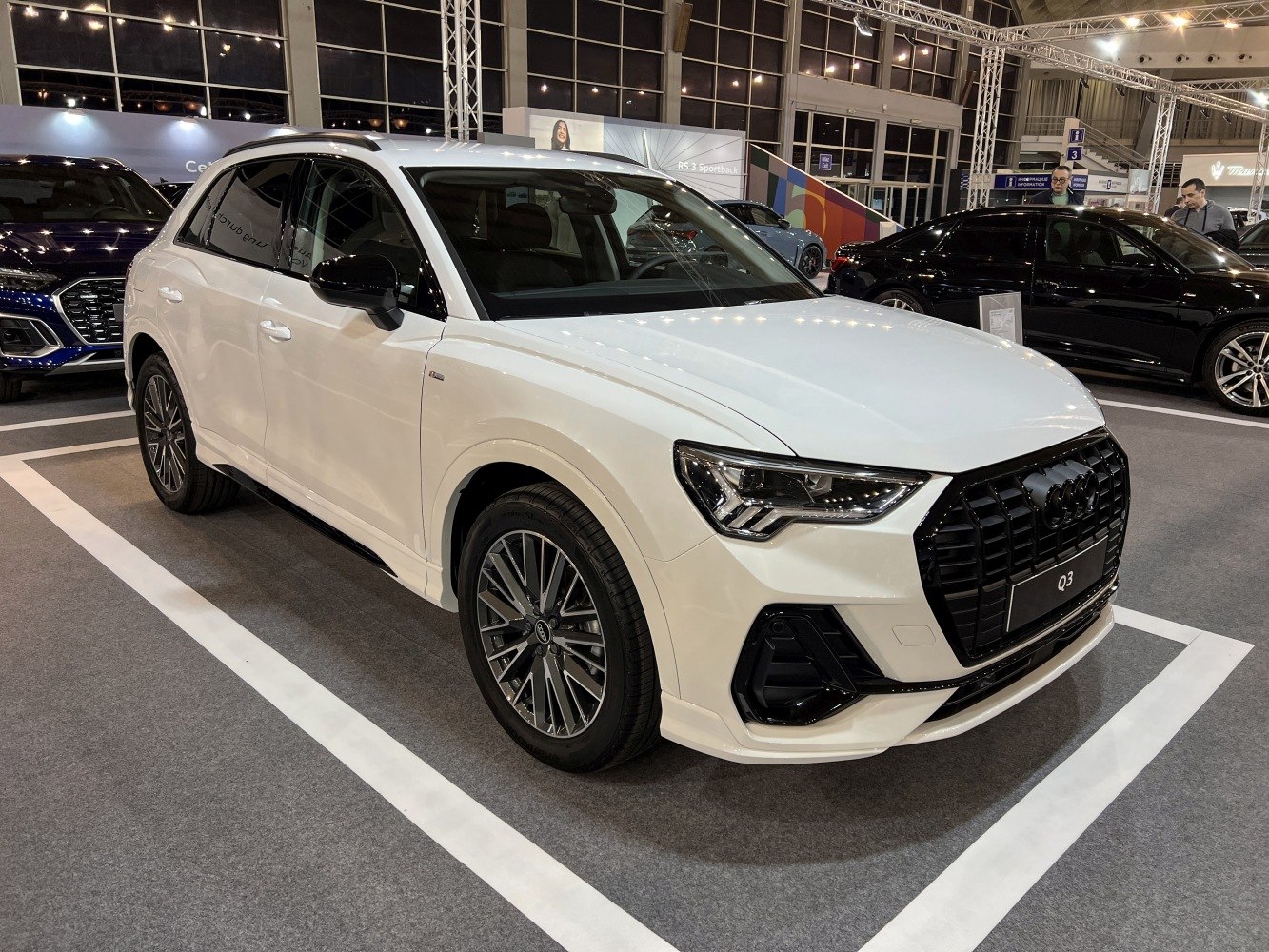 Front grille and sleek side profile of a white modern SUV