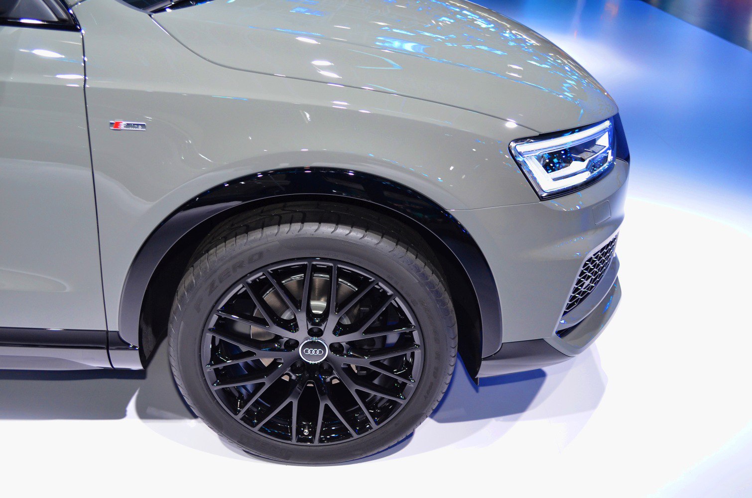 Front wheel with black alloy rim and LED headlight on a modern vehicle