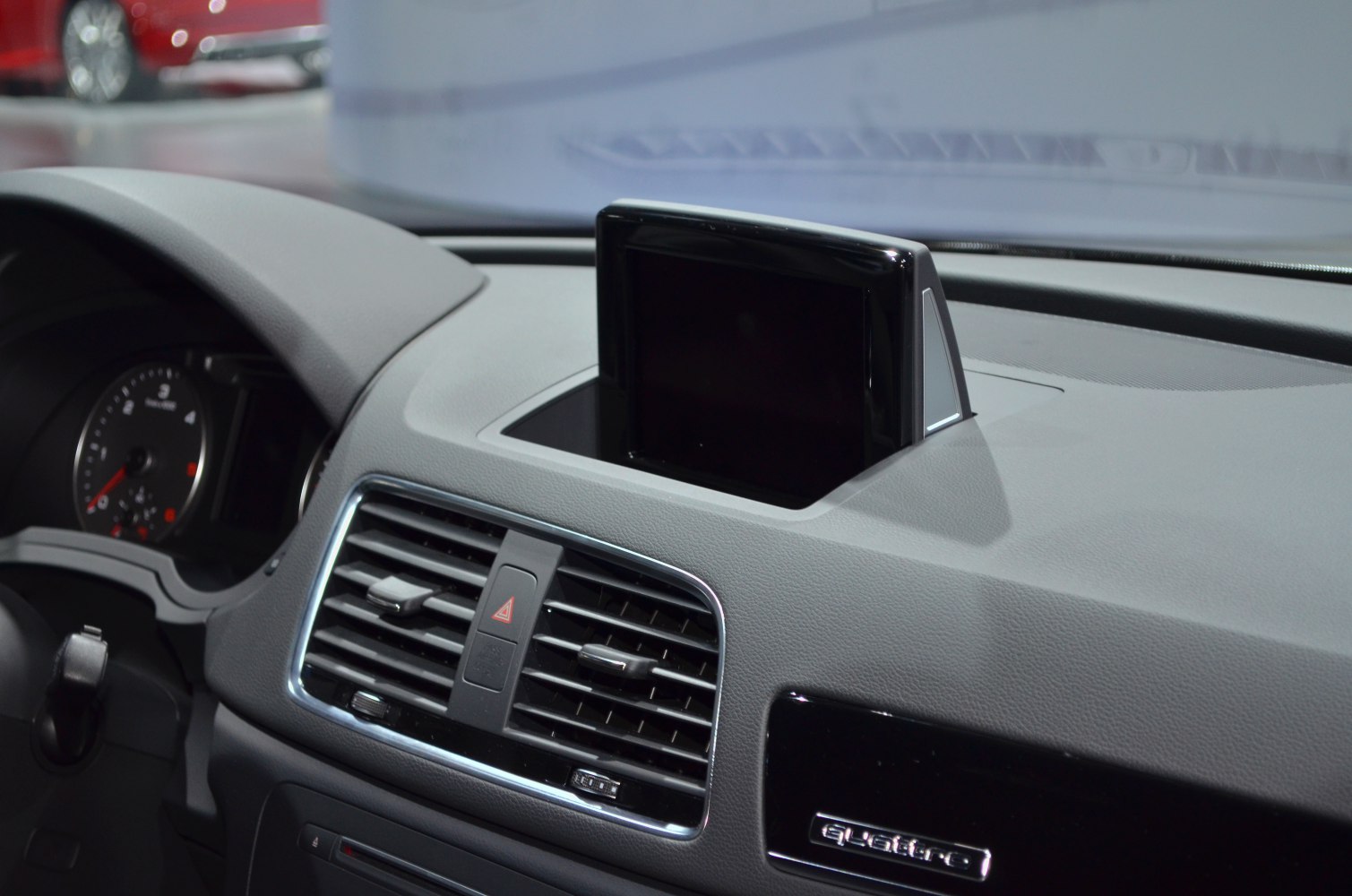 Pop-up center console display and air vent grille with hazard button