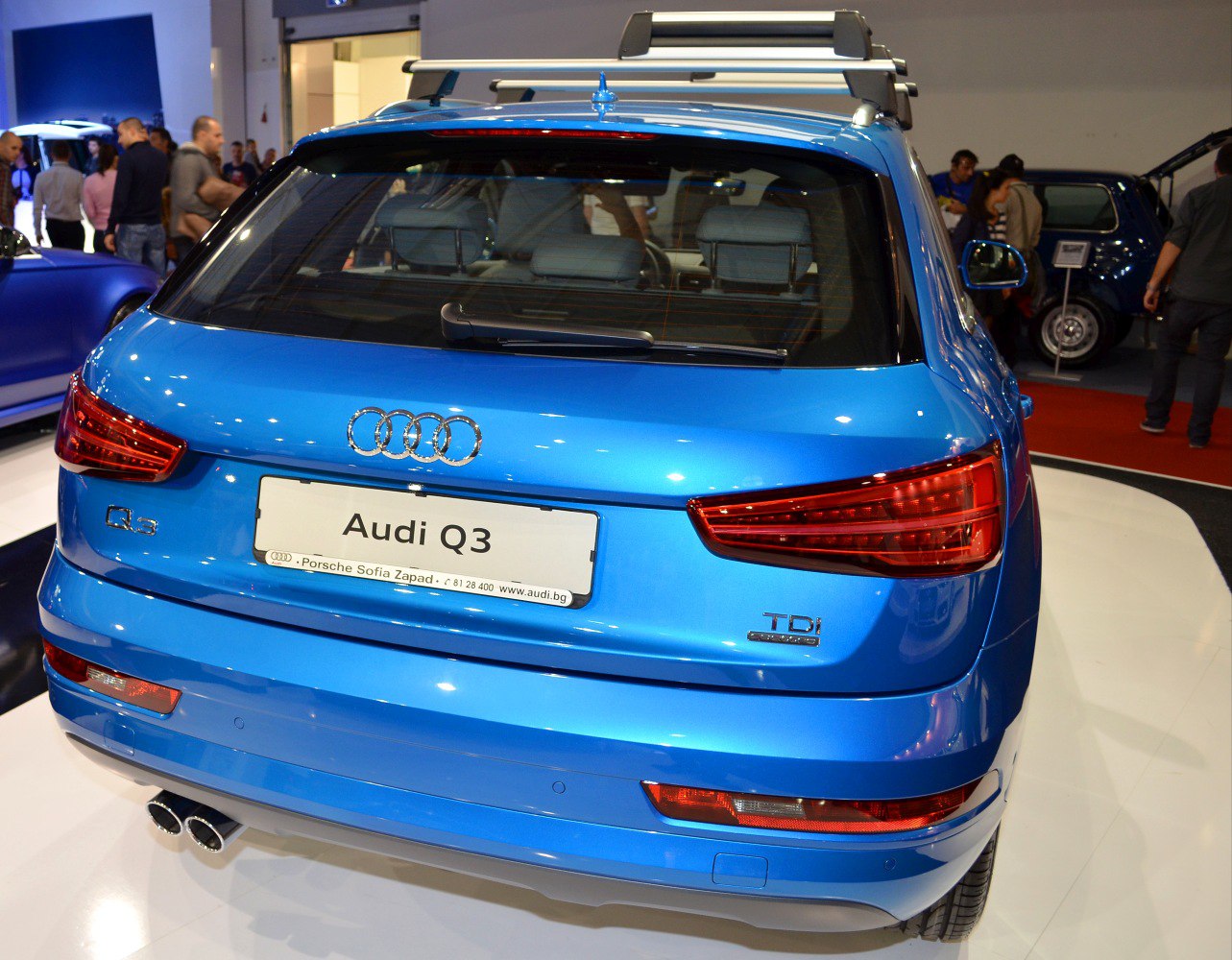 Blue compact SUV rear with TDI badge, dual exhaust, and roof rack