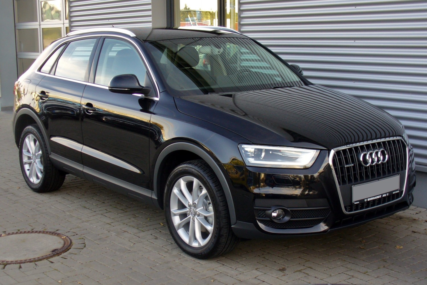 Black compact SUV front-side view with alloy wheels and distinctive headlights