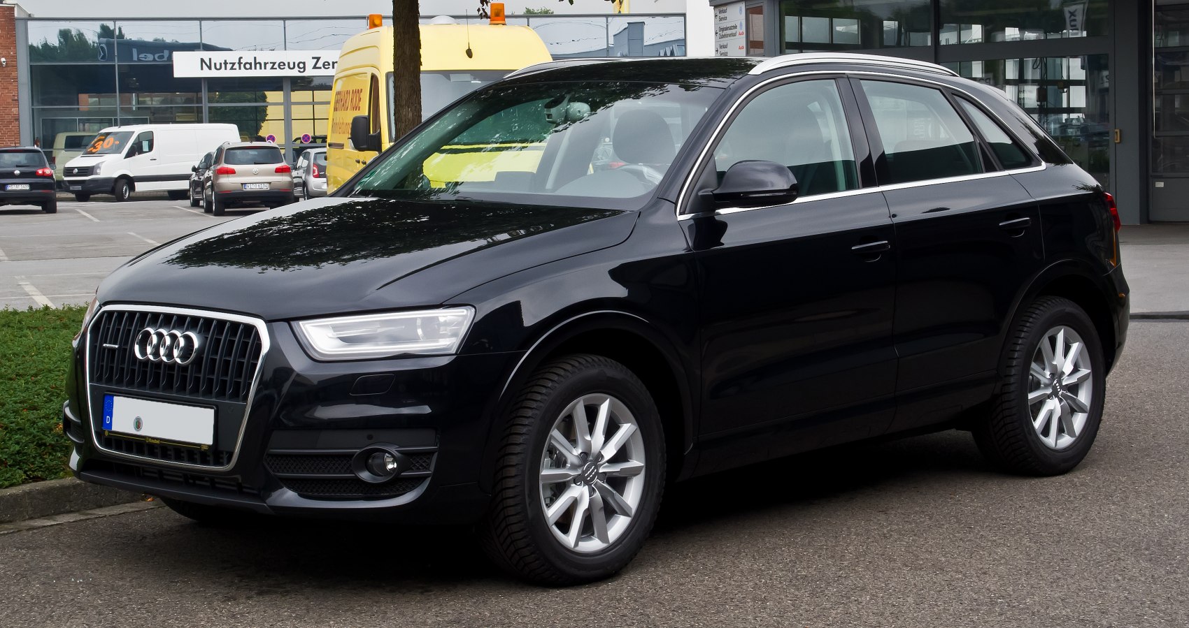 Front side view of black compact SUV with alloy wheels