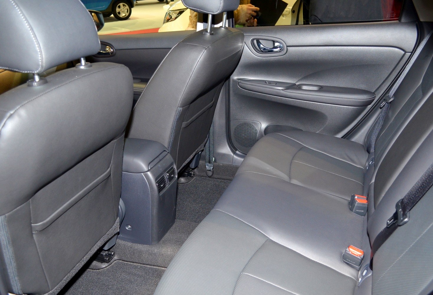 Rear seating area with black leather upholstery and rear air vents