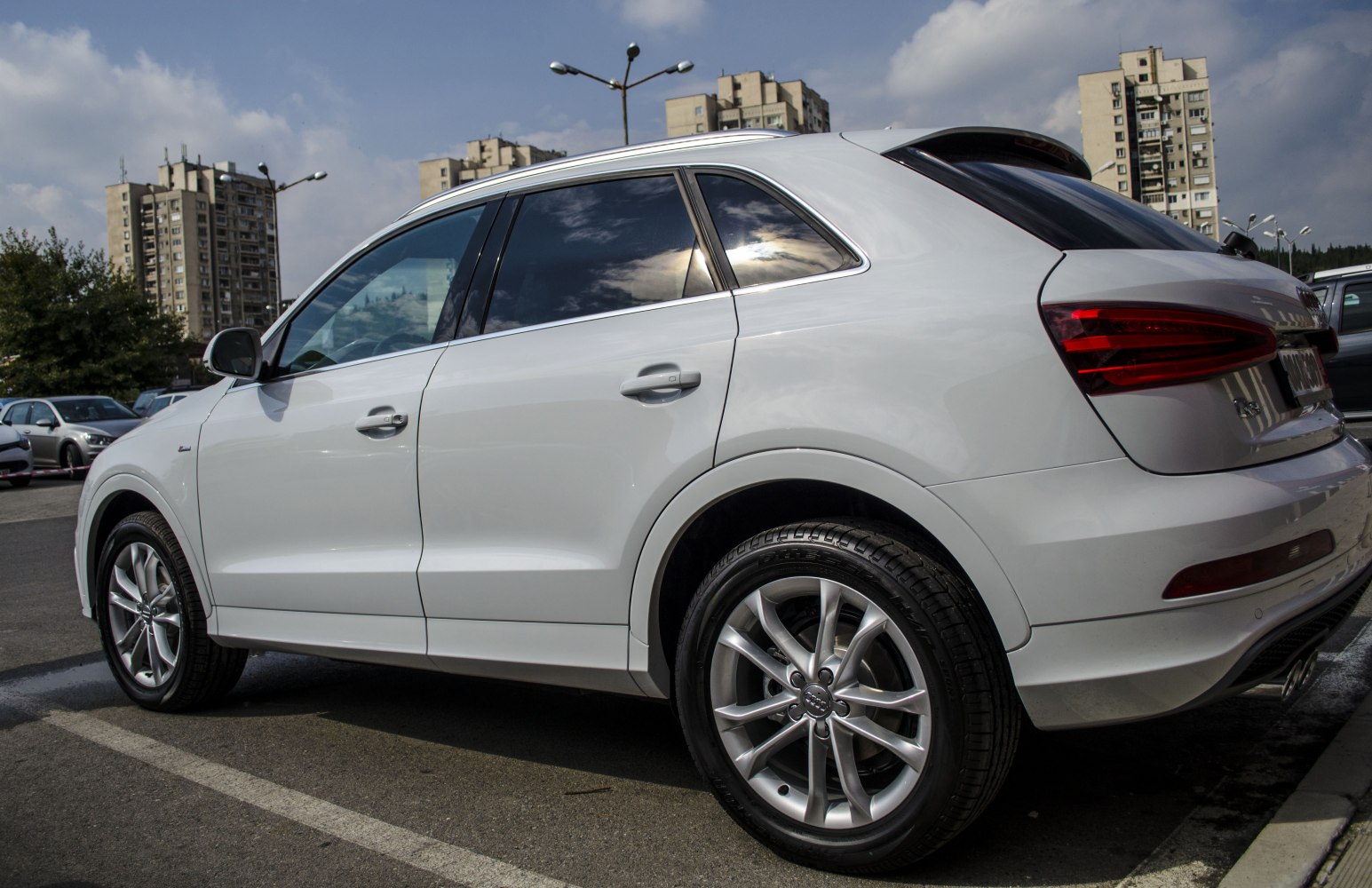 Rear-side view of white SUV with alloy wheels