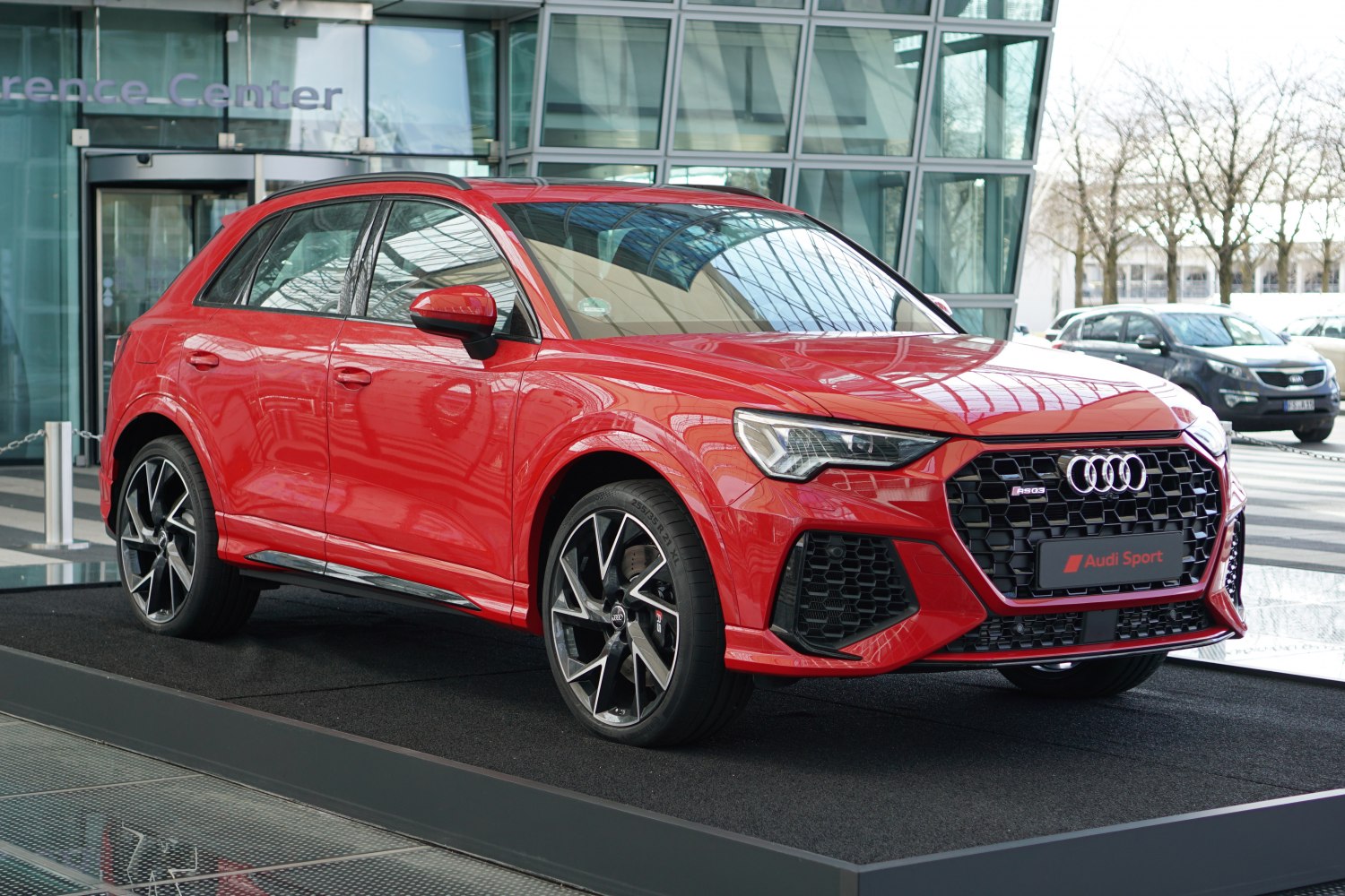 Red SUV with aggressive front grille and stylish alloy wheels