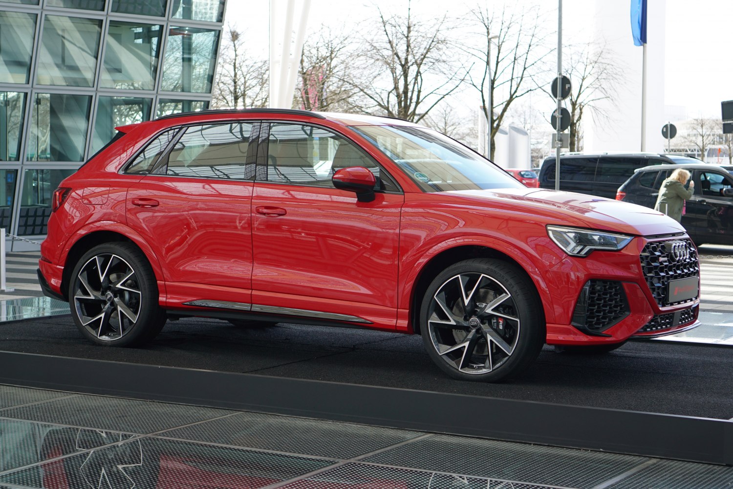 Red SUV side view with sporty alloy wheels