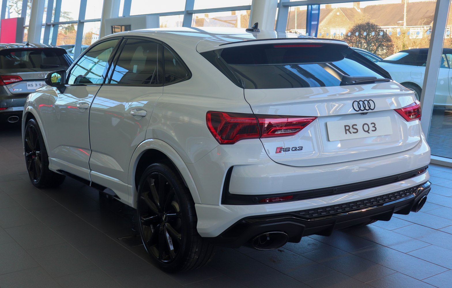 Sporty rear end and black alloy wheels of a compact SUV