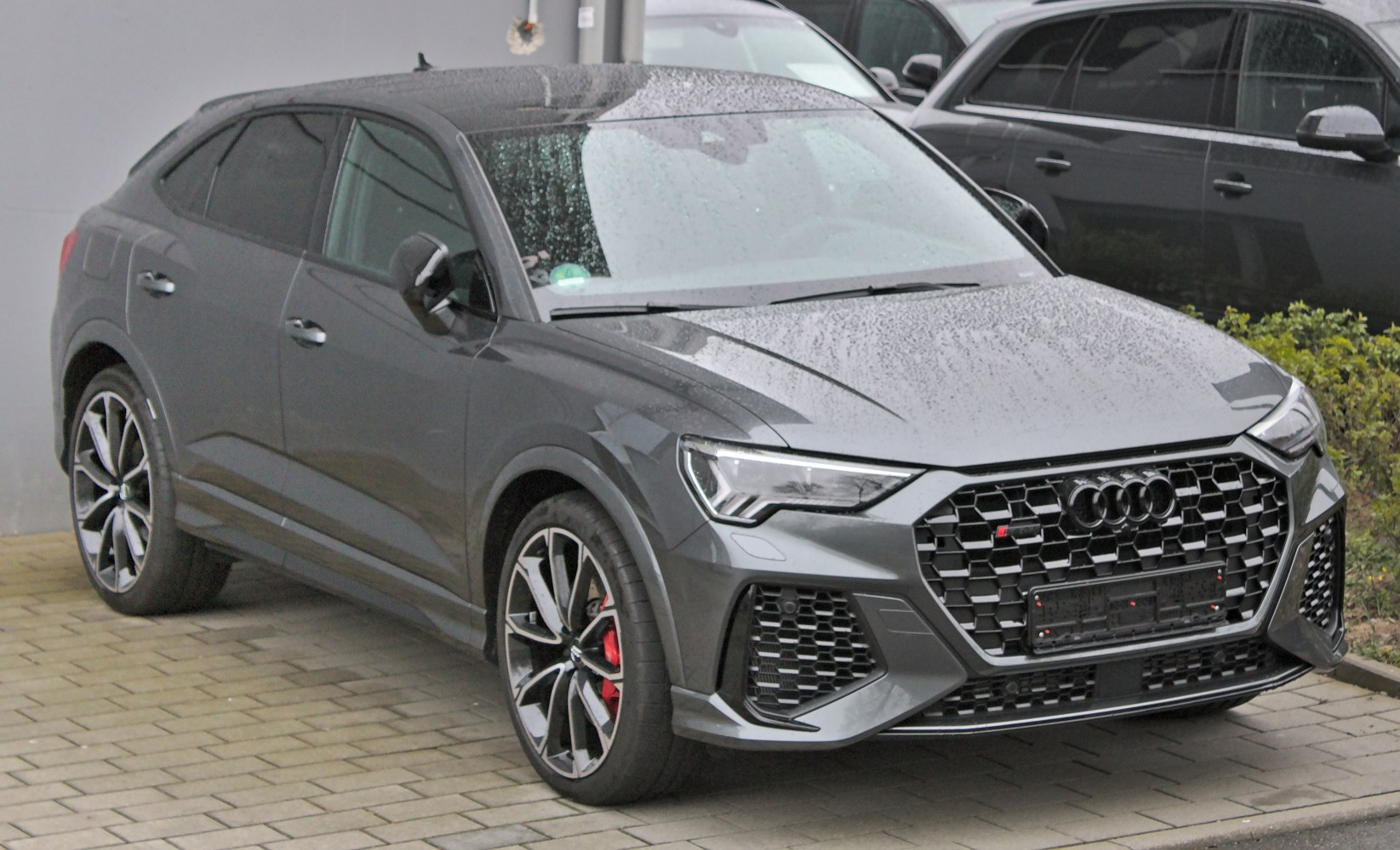 Sleek coupe-style SUV front with honeycomb grille and LED headlights