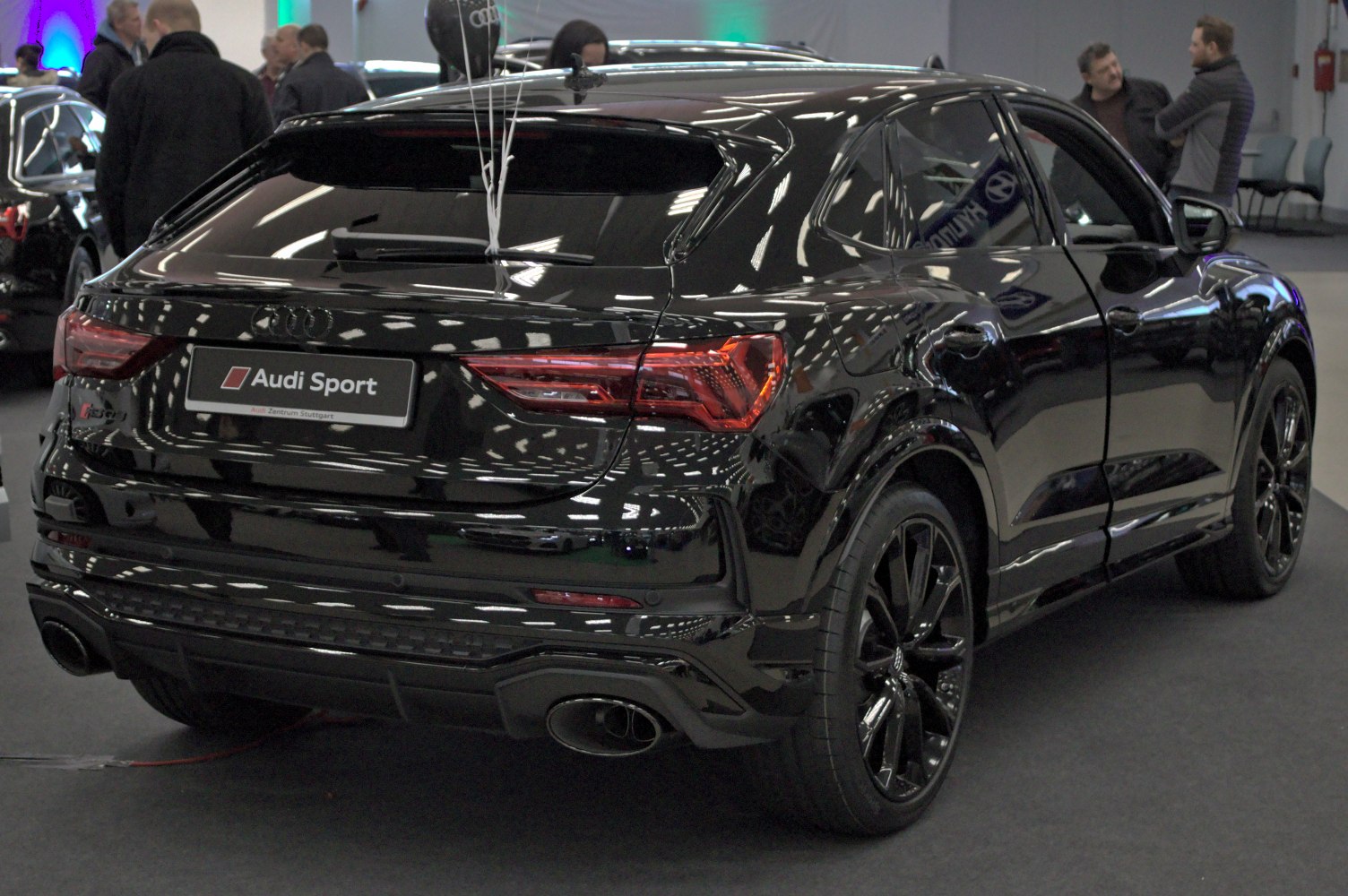 Sporty hatchback rear with black alloy wheels and dual exhaust