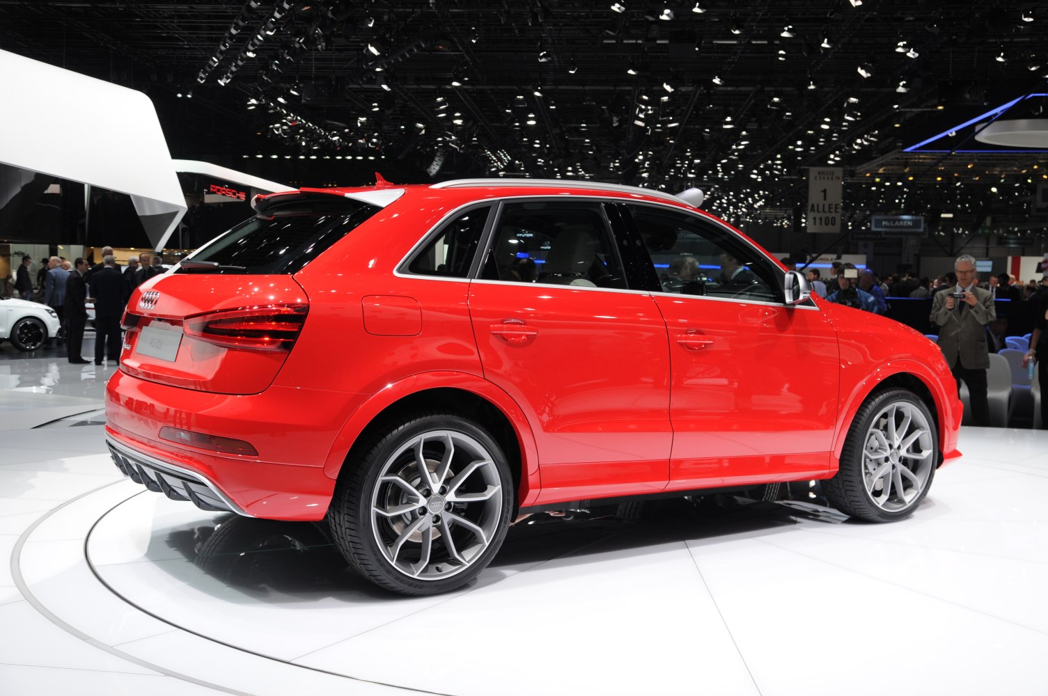 Sporty red compact SUV with distinctive alloy wheels showcased at auto event
