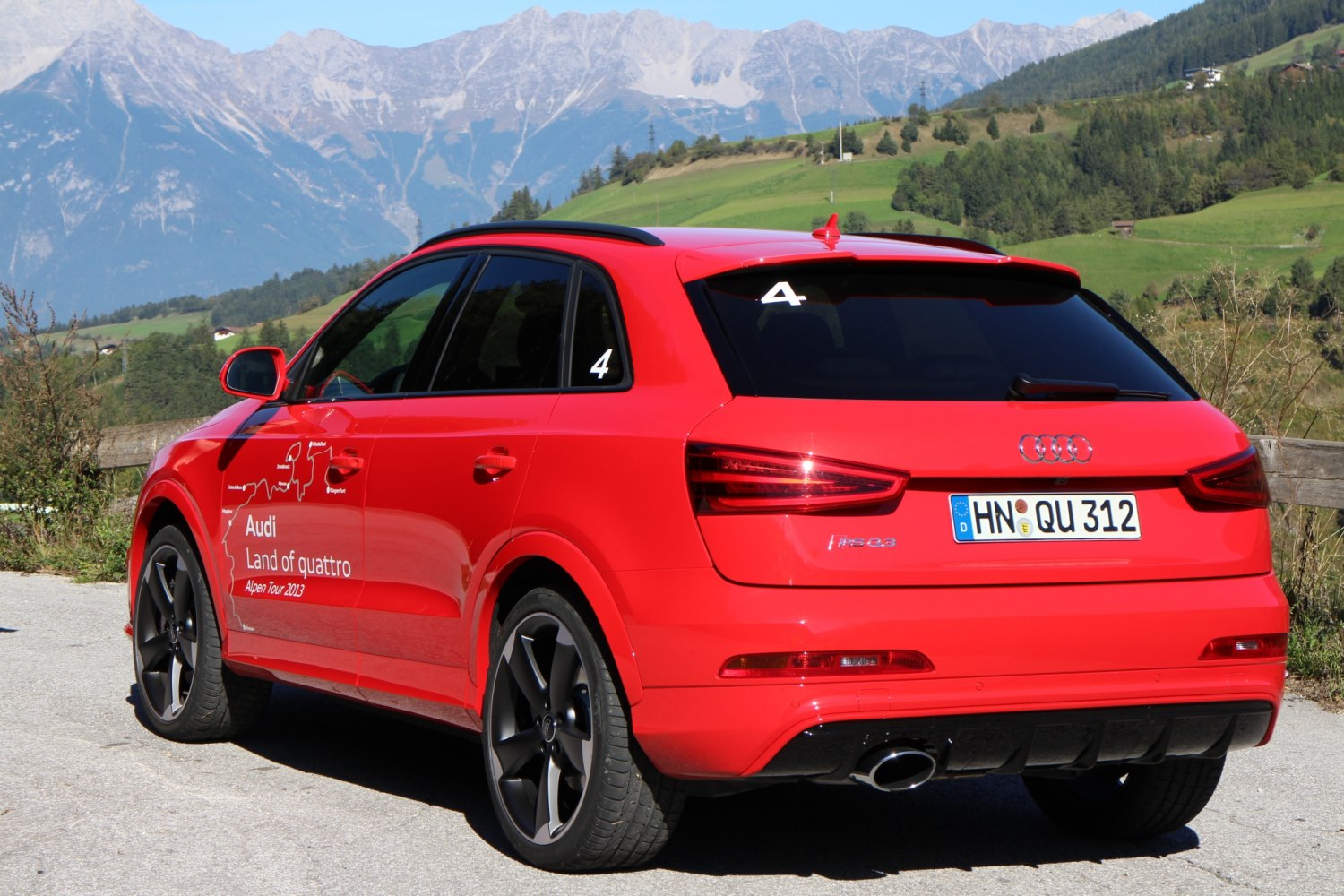 Red SUV rear view with black rims and sporty exhaust